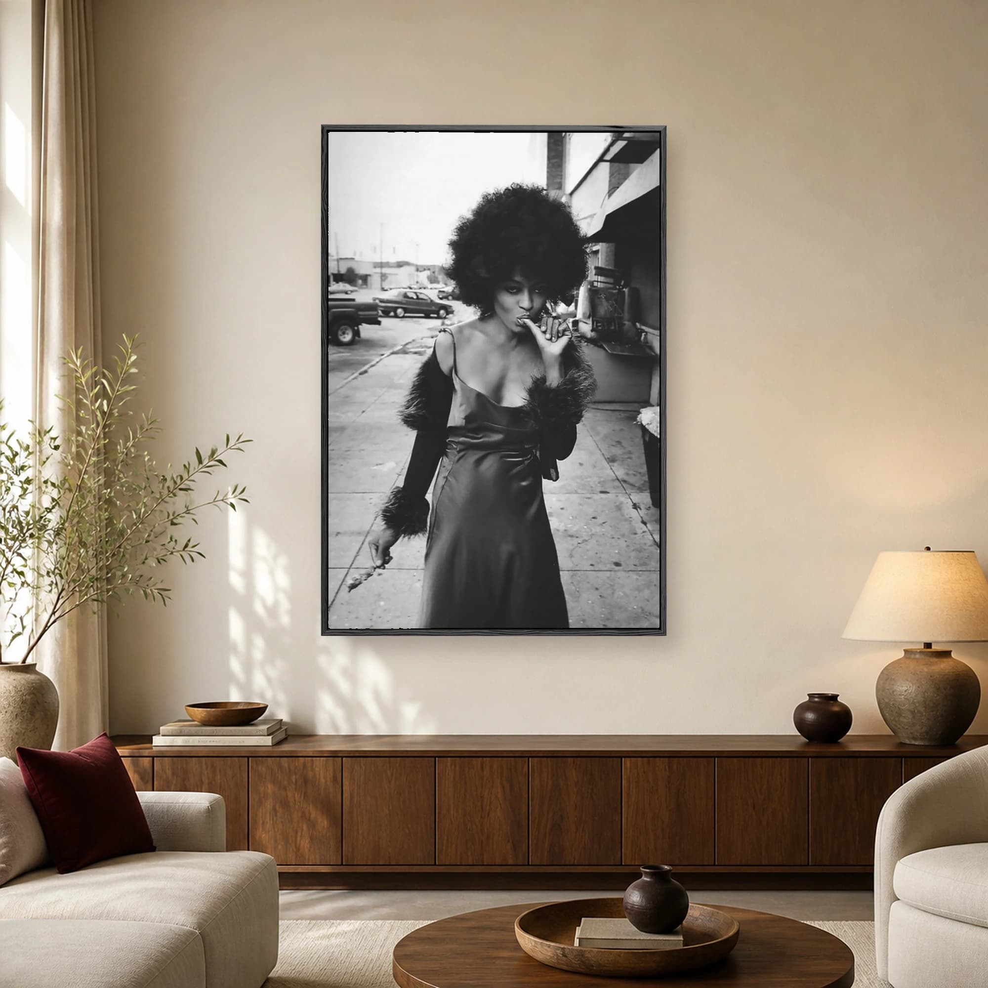 Black and white portrait photograph of a woman with a large afro hairstyle wearing a slip dress with fur accents on an urban street.