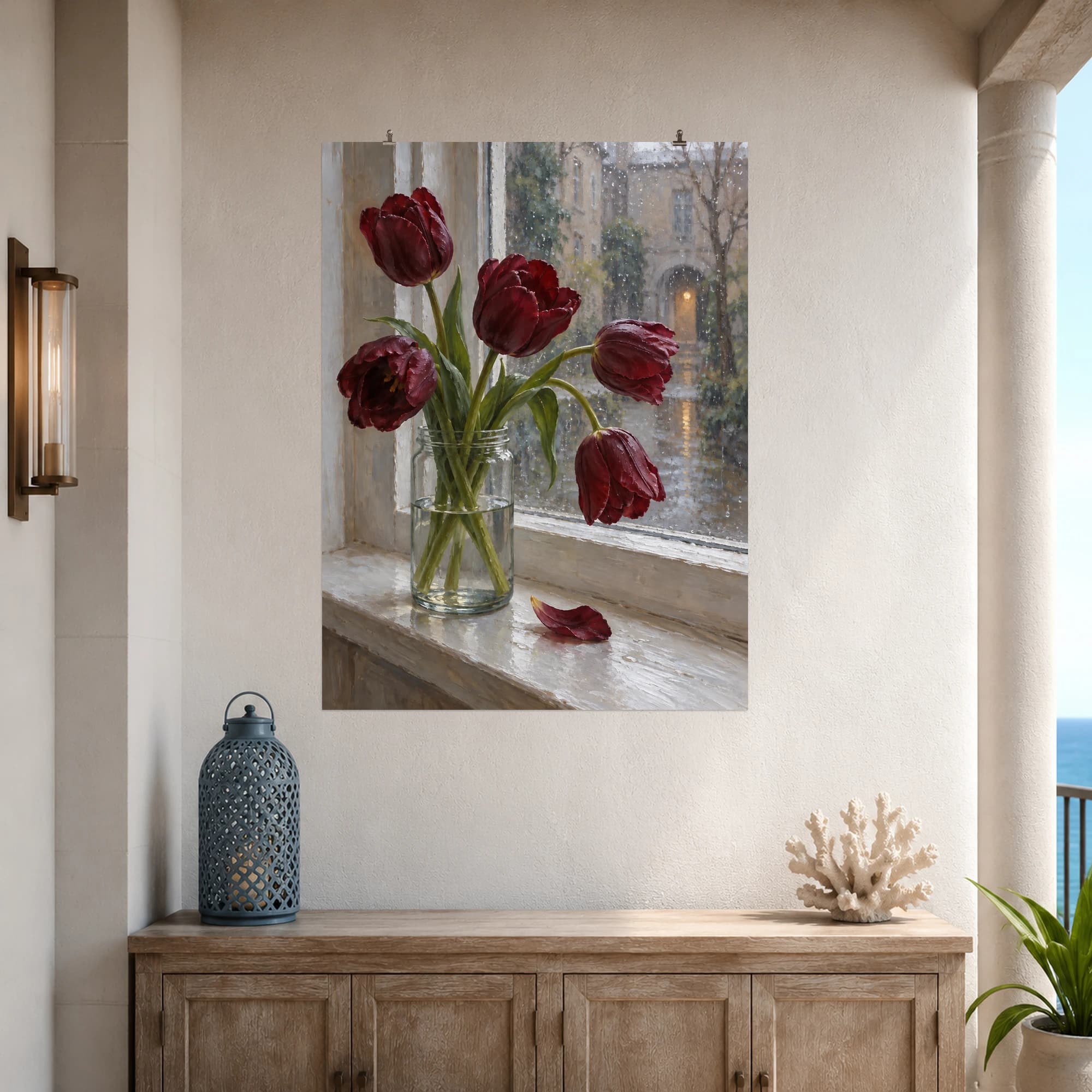 Burgundy tulips lean from a clear glass jar beside a rain-streaked window.