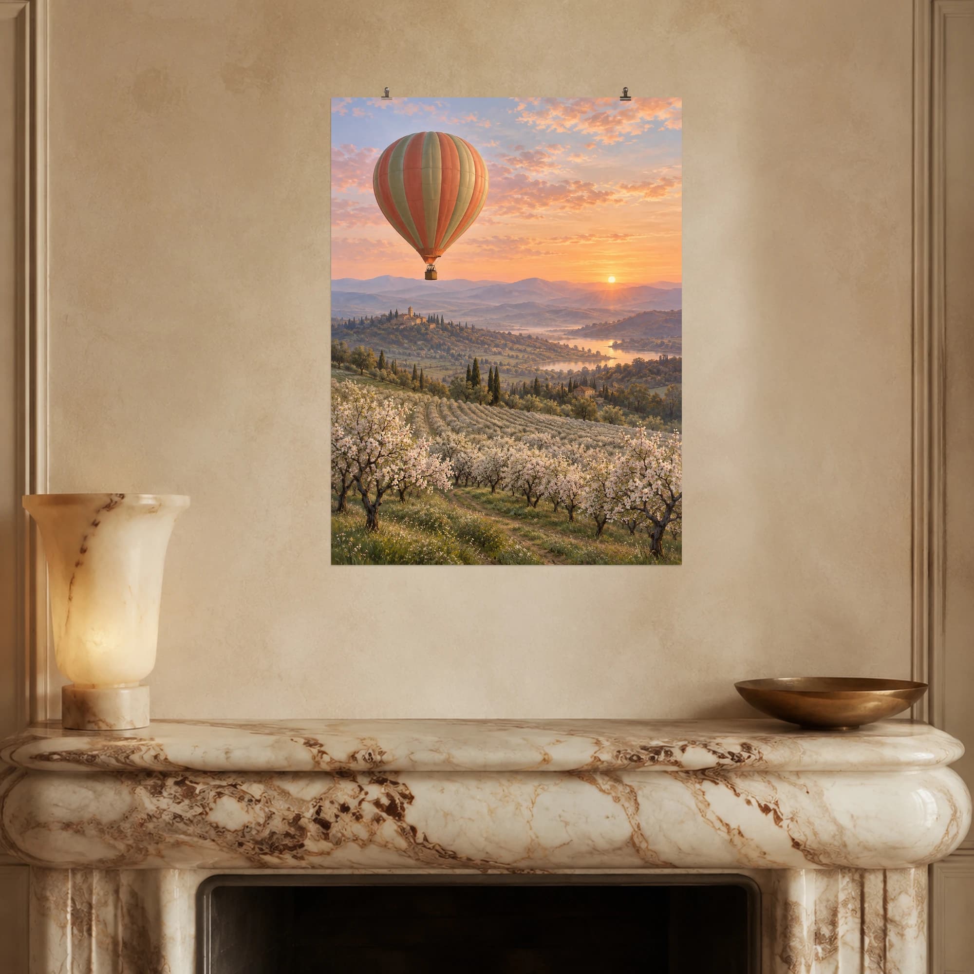 A coral and sage balloon drifts above flowering orchards in the warm light of dawn.