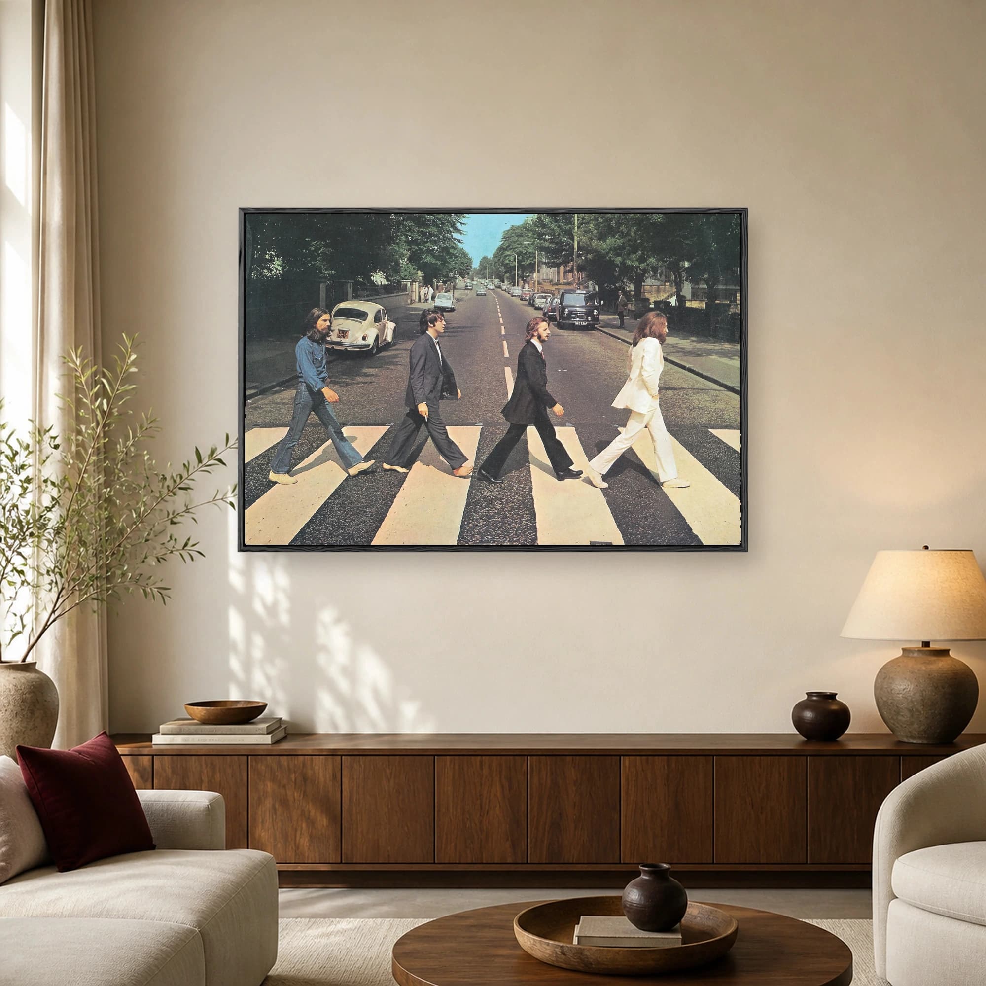Four men walking across a zebra crosswalk on an urban street in a famous vintage photograph composition