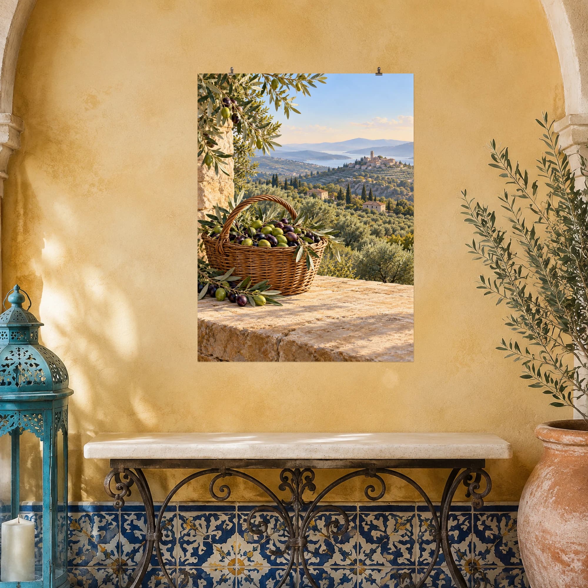An olive-filled basket rests on a sunlit stone wall above a peaceful grove. Silver-green leaves and distant hills evoke a leisurely Mediterranean harvest.