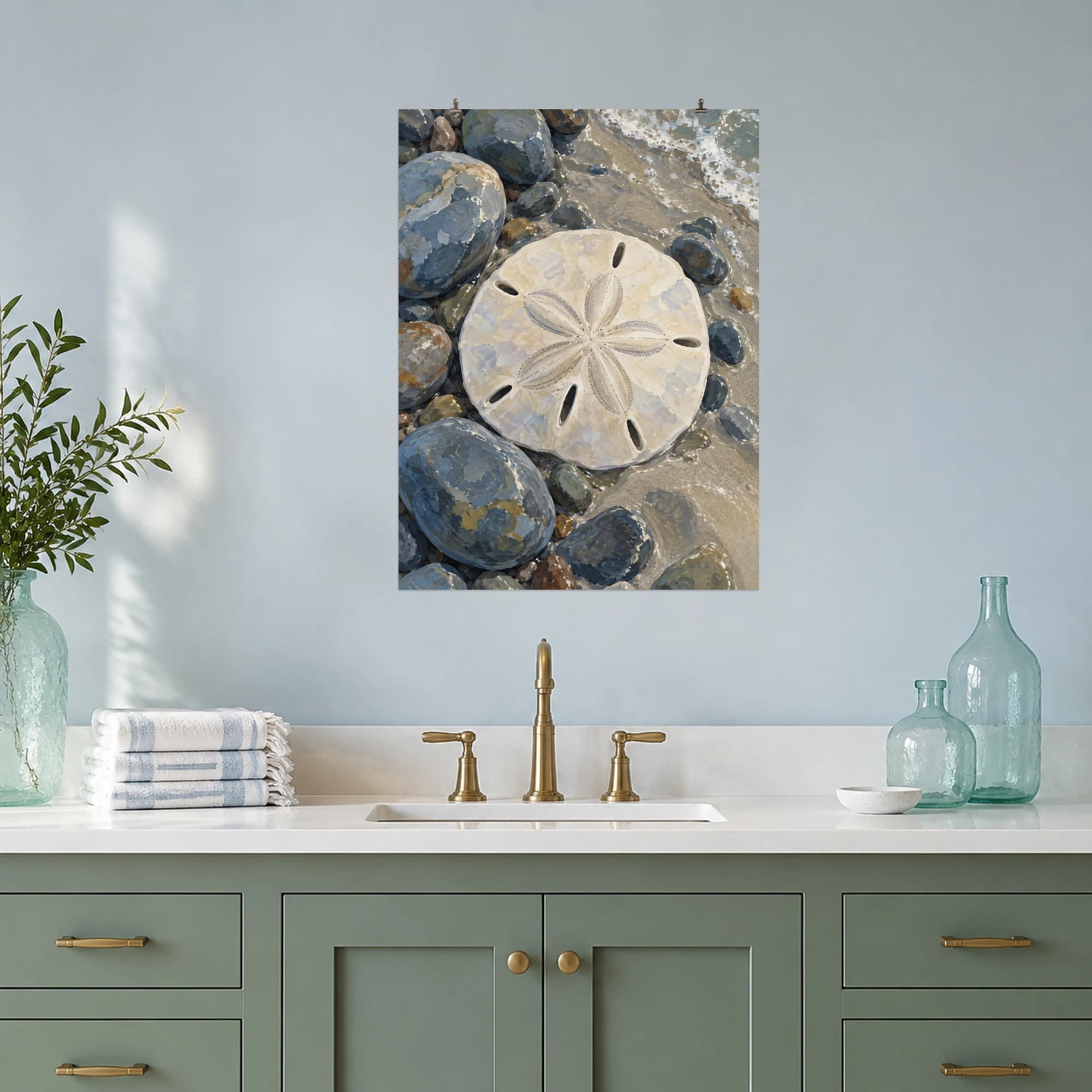 This gouache-style composition features a pale sand dollar with its natural five petal pattern on blue grey beach pebbles and soft wet sand. Expressive brushwork and carefully balanced color bring a distinctive focal point to your wall.