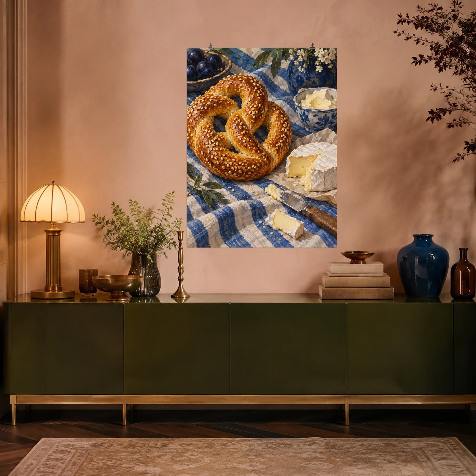 This gouache-style composition features a golden sesame coated twisted pretzel beside soft cheese and a small knife on blue striped linen. Expressive brushwork and a balanced palette bring warmth and character to your space.