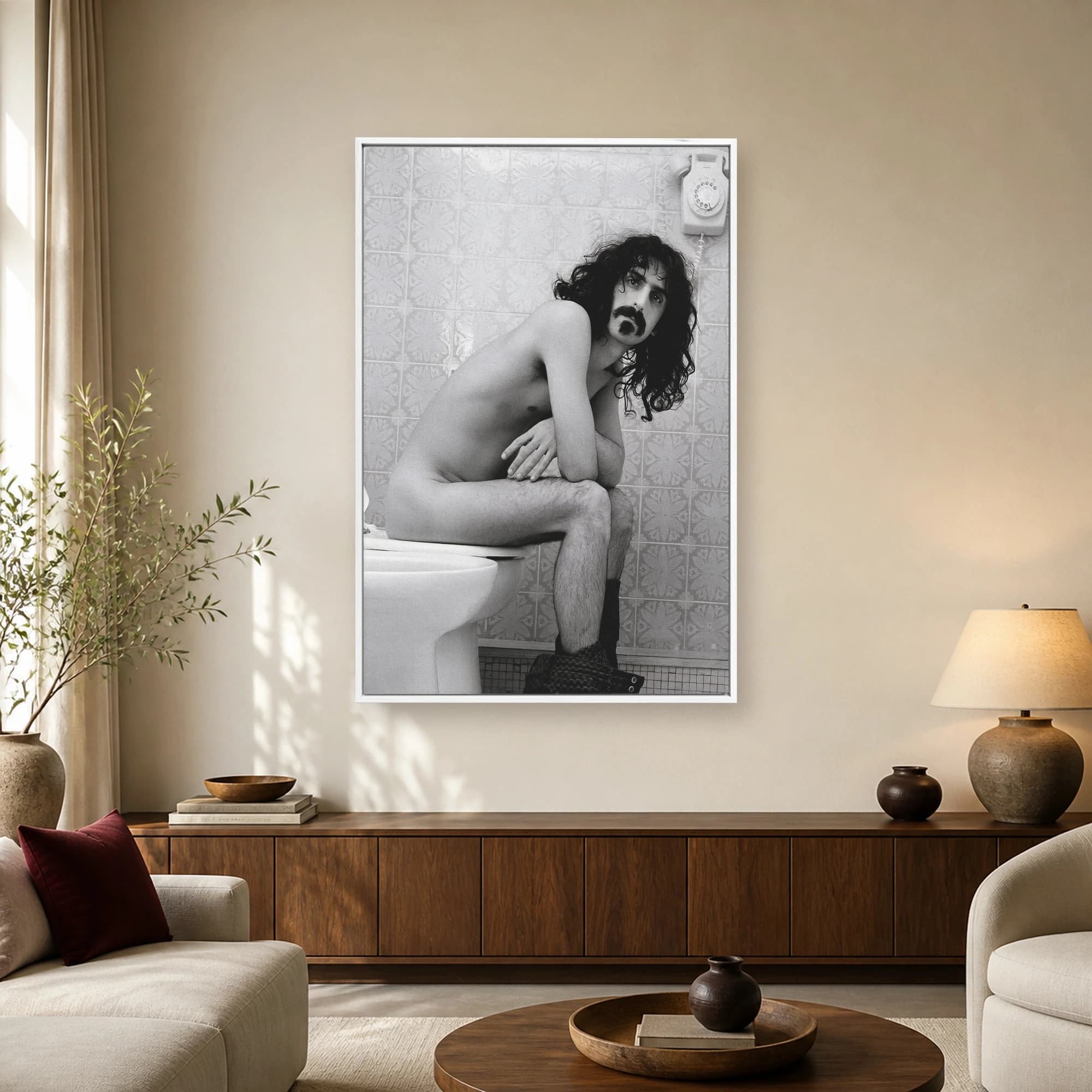 Black and white fine art print featuring musician Frank Zappa seated humorously on a toilet in a tiled bathroom.