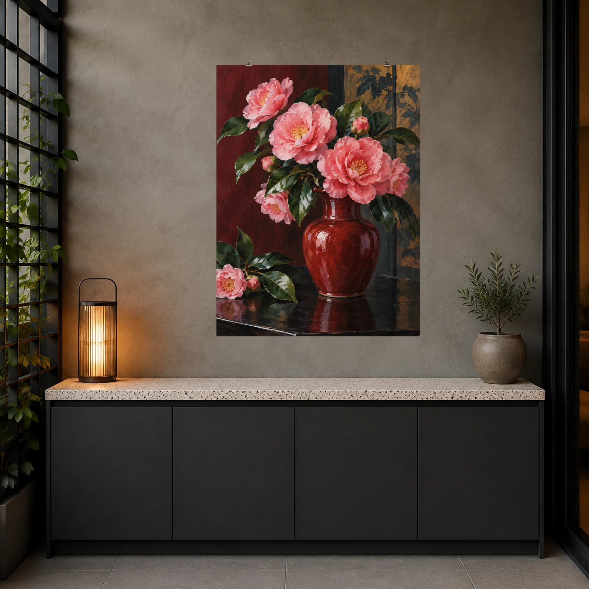 This gouache-style composition features pink camellias in a deep red ceramic vase on a dark table beside glossy green leaves. Expressive brushwork and carefully balanced color bring a distinctive focal point to your wall.