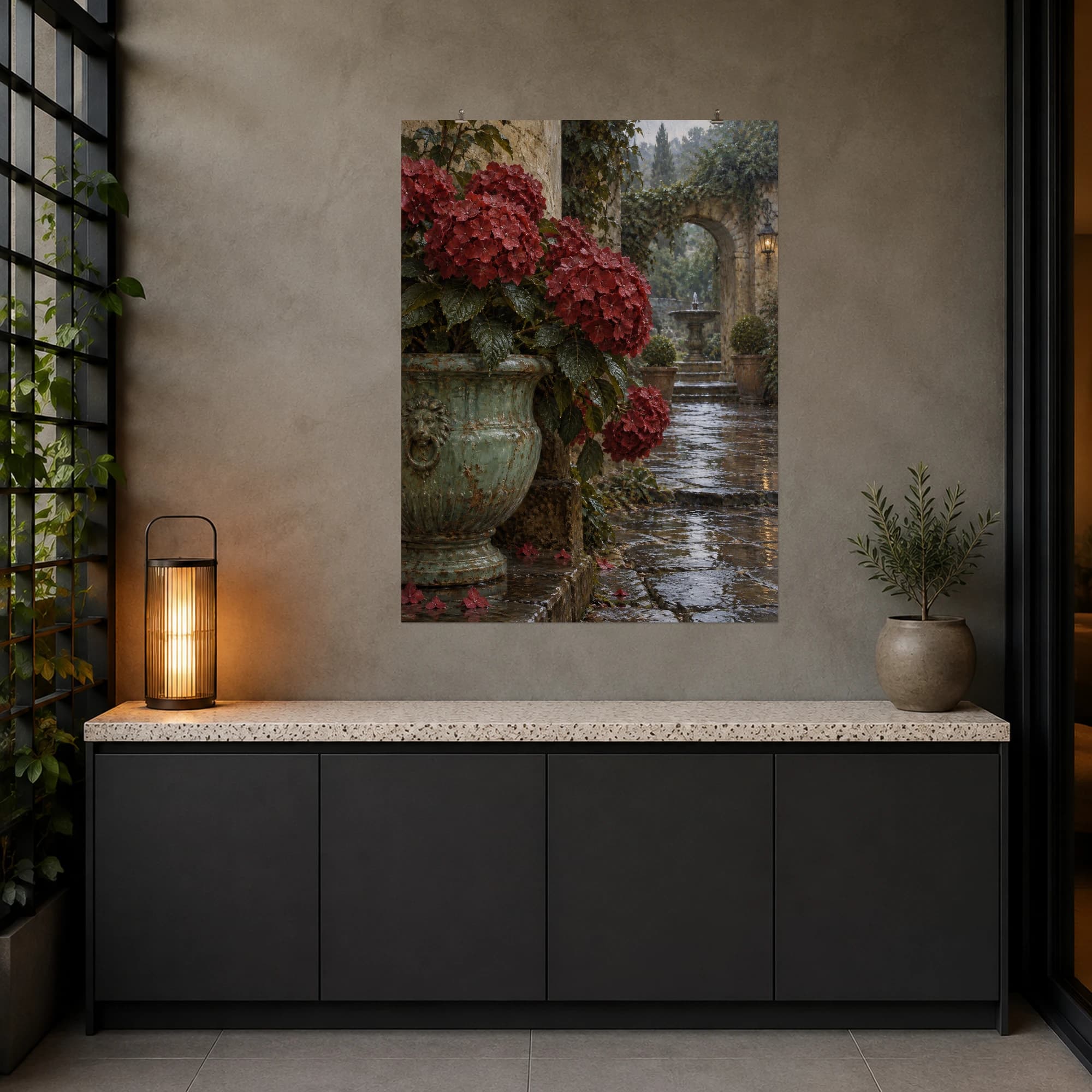 Crimson hydrangeas spill from an aged celadon urn beside a rain-dark courtyard. Rich reds and weathered stone give this floral scene a quiet, intimate mood.