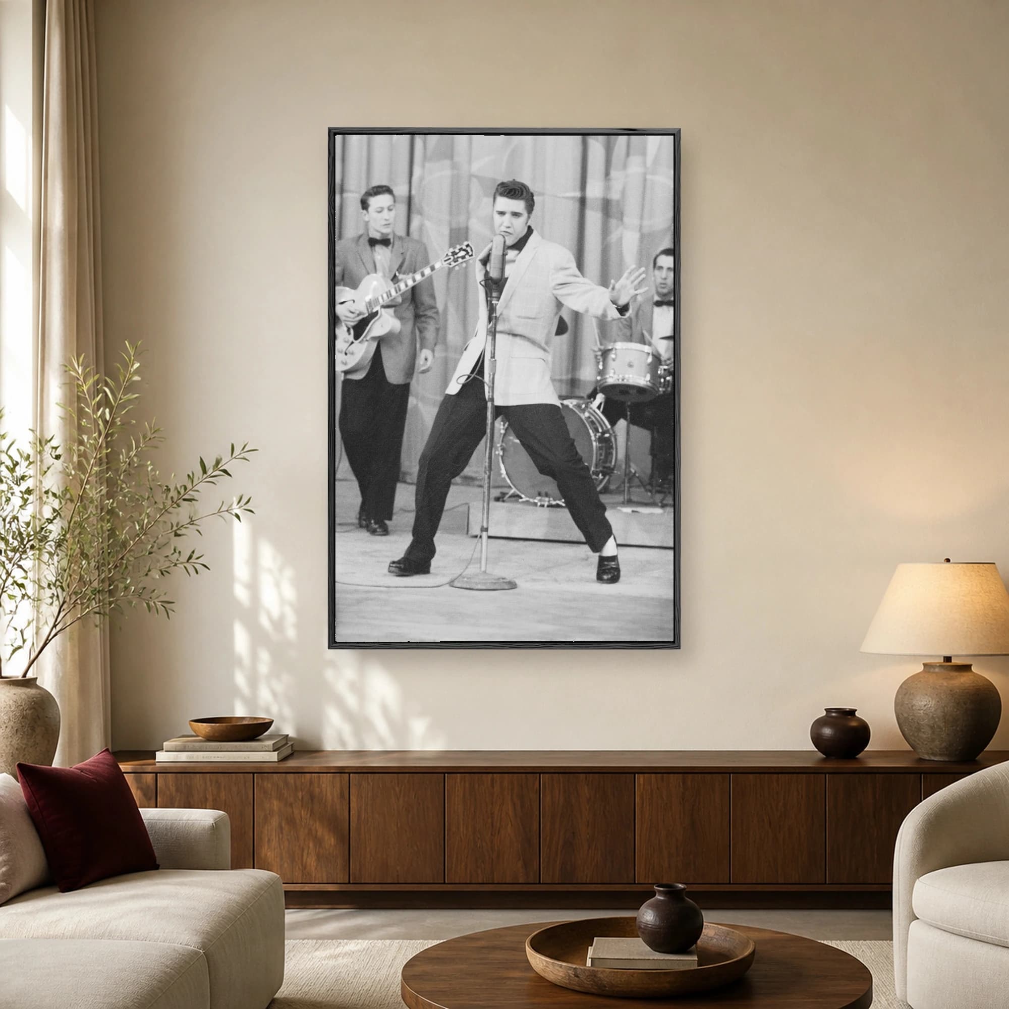 Black and white vintage photograph of Elvis Presley singing dynamically into a microphone on stage with his band