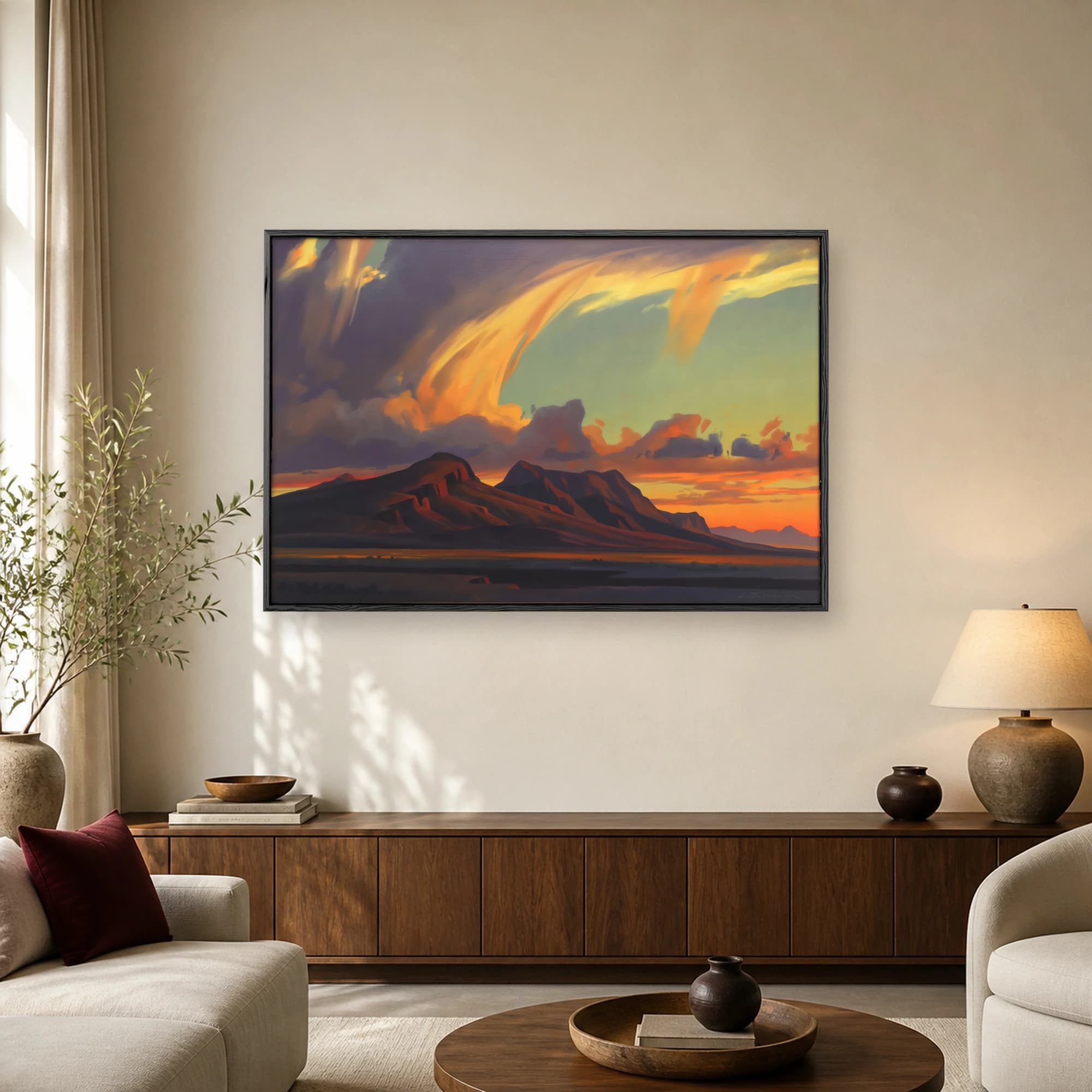 A painting of dark mountain ridges beneath a dramatic swirling sunset sky with glowing golden clouds.