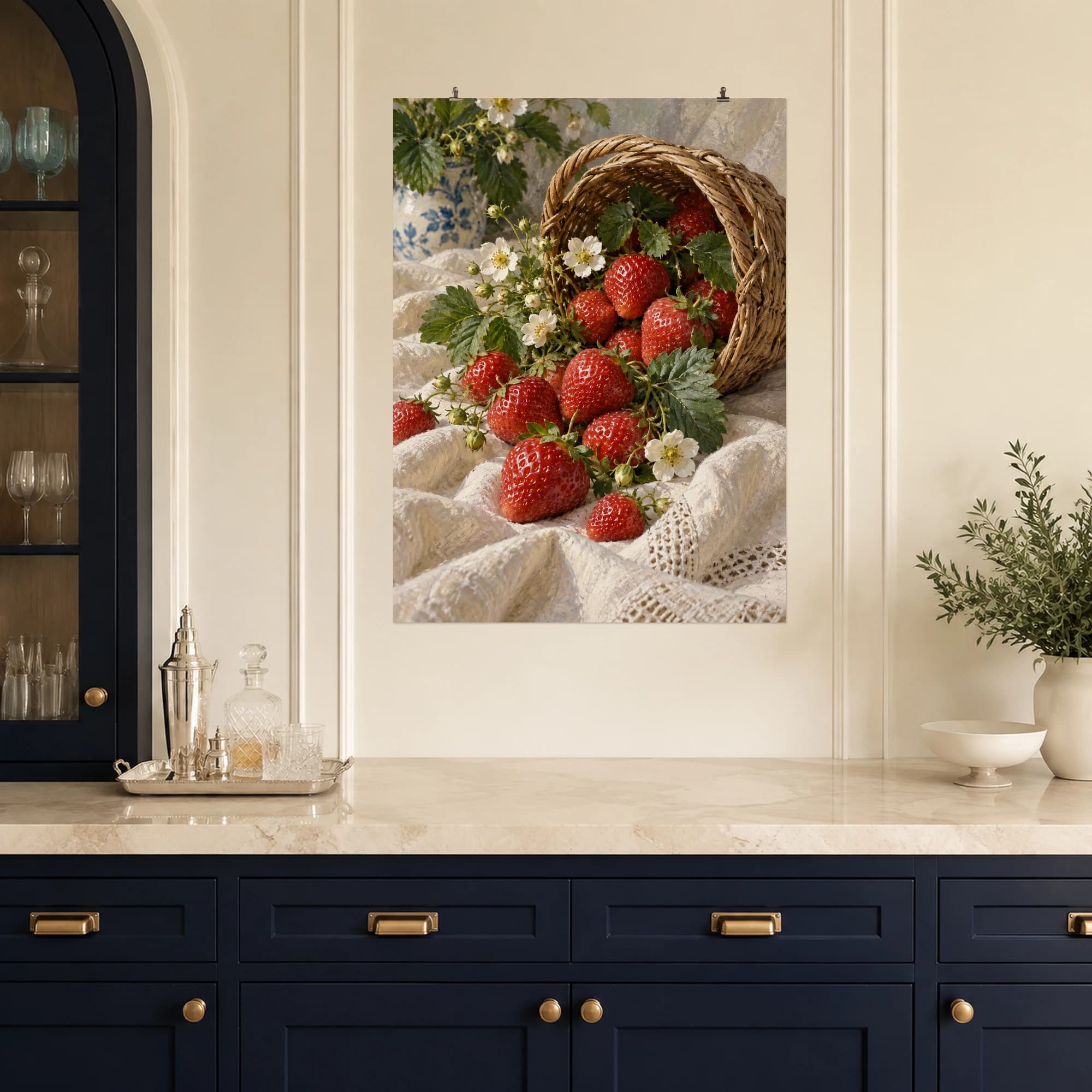Fresh strawberries fill a basket beside pale linen and small blossoms. Warm reds and gentle light make this a welcoming kitchen still life.