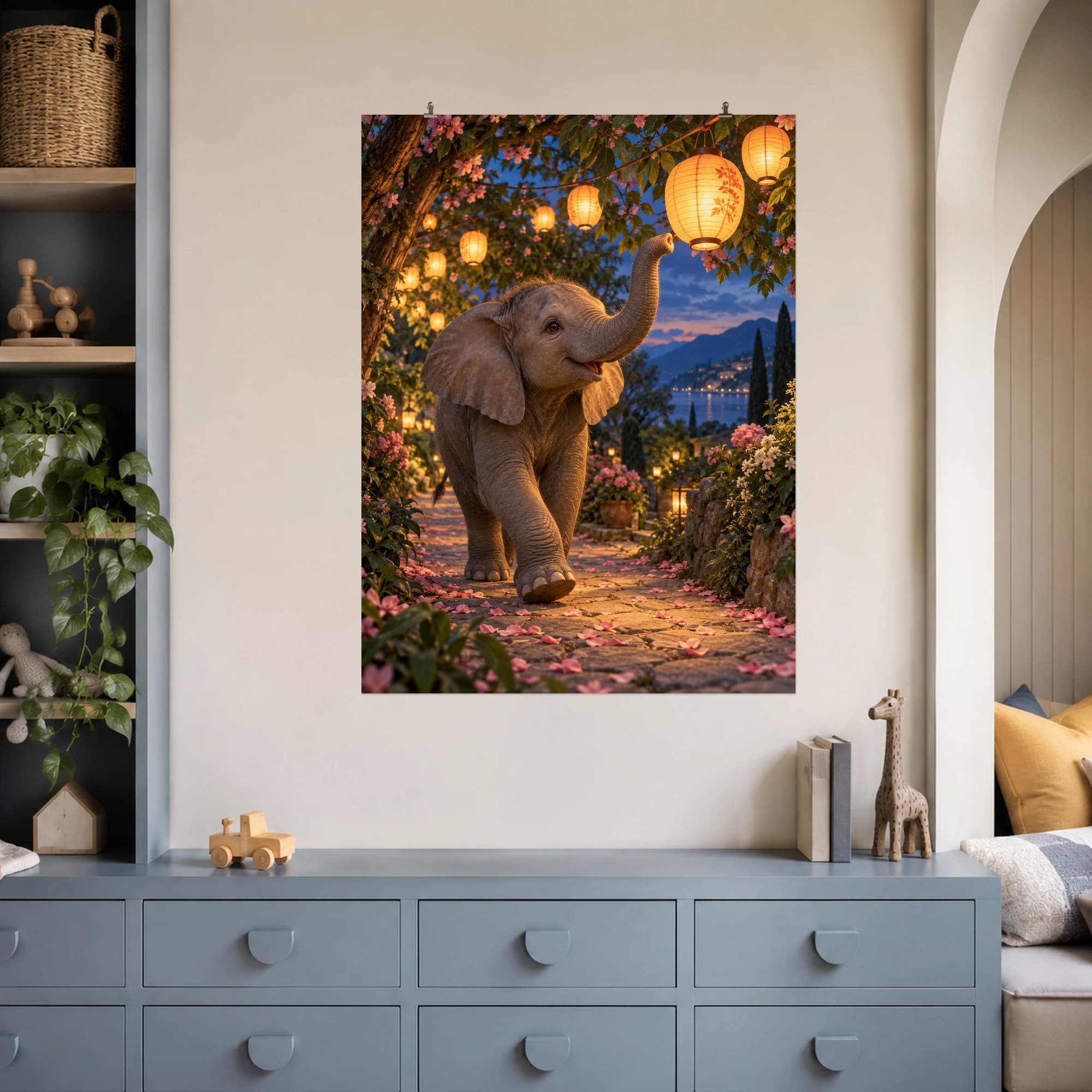 A young elephant wanders through a flower-filled garden beneath glowing paper lanterns.