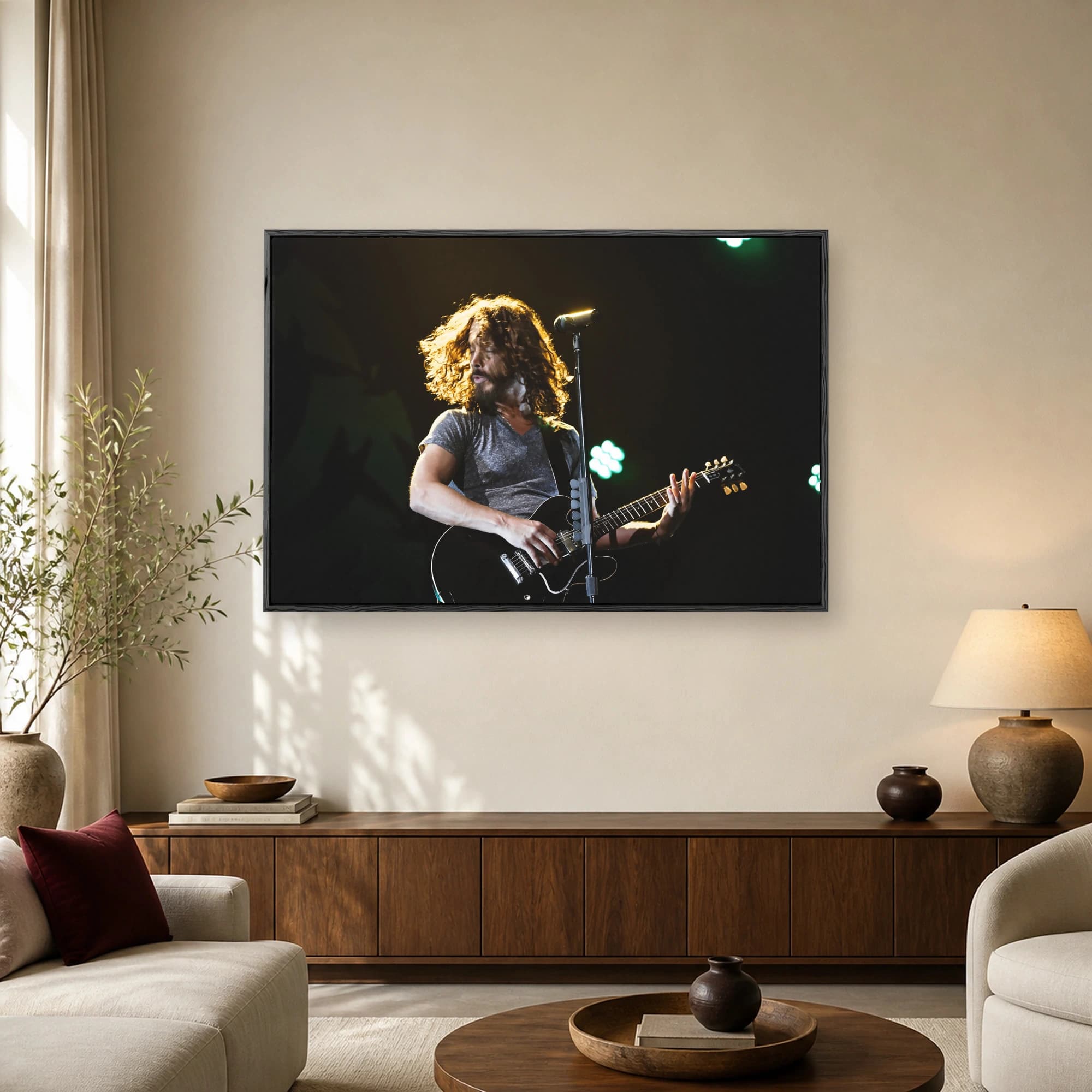 A rock musician with long curly hair playing a black electric guitar on stage under dramatic golden and green concert lighting.