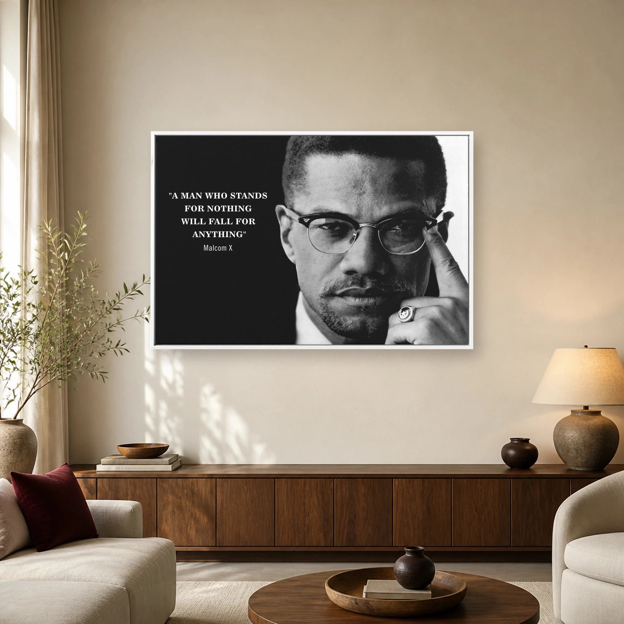 Monochrome portrait of Malcolm X with glasses alongside his quote A man who stands for nothing will fall for anything.