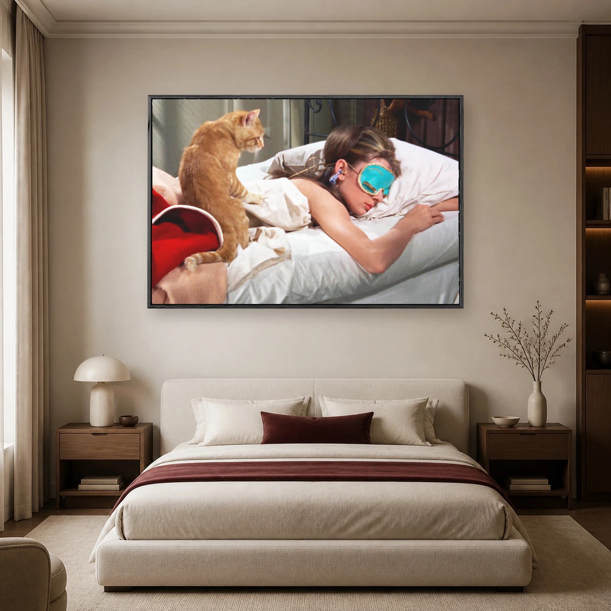 Cinematic wall art print of Audrey Hepburn wearing a turquoise sleeping mask in bed with an orange tabby cat looking down.