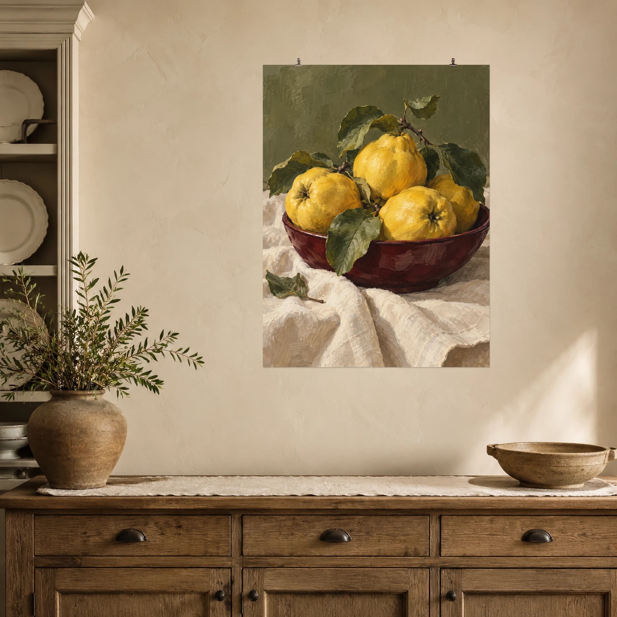 Golden quinces rest in a burgundy bowl on cream linen. Olive green tones and textured brushwork give this fruit still life a warm, quiet character.