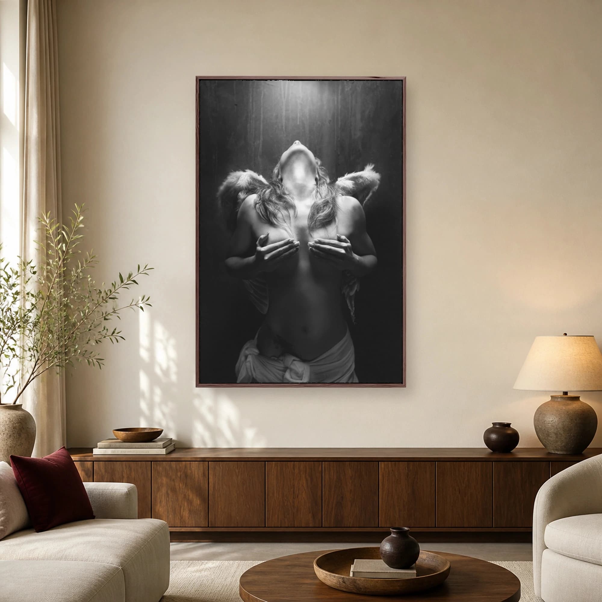 Black and white fine art photograph of a figure with angel wings, head tilted back and hands across chest against a dark textured wall