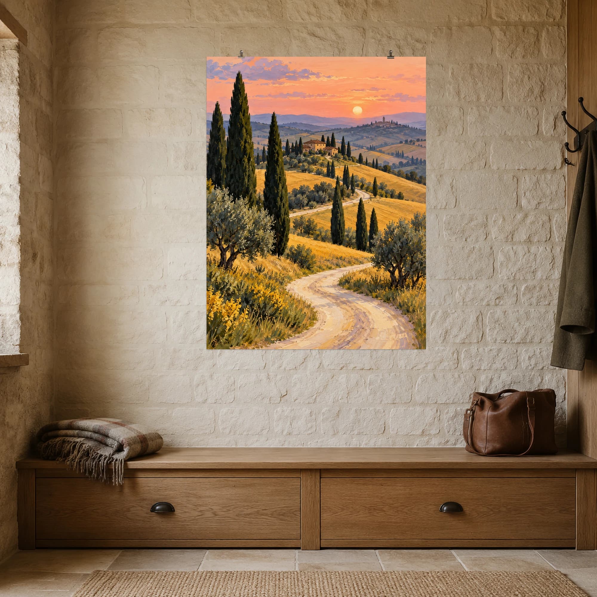 A winding path leads through golden hills and tall cypress trees toward distant villages. The peach evening sky lends a warm, unhurried atmosphere to this countryside landscape.