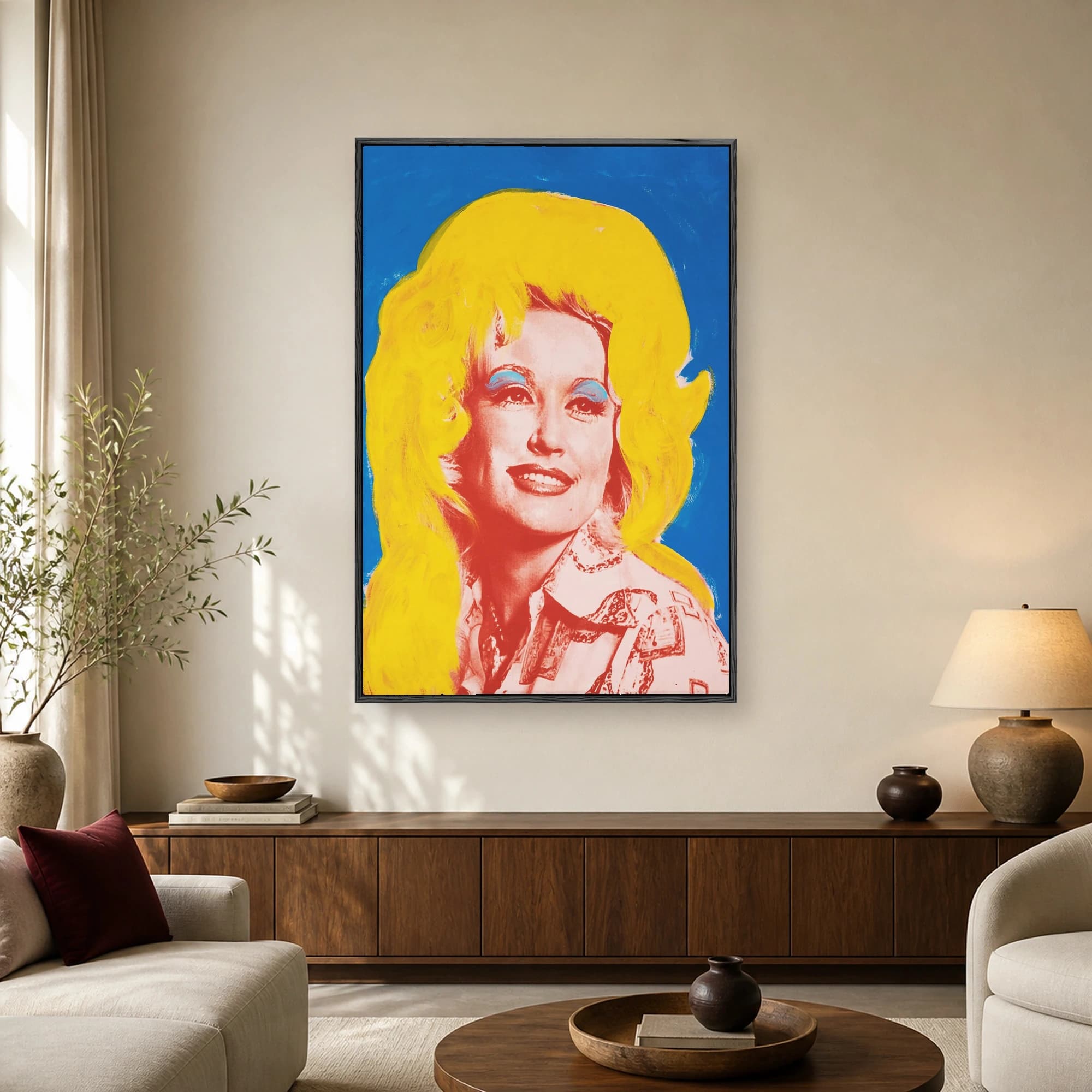 Pop art portrait of country music icon Dolly Parton with bright yellow hair, blue eyeshadow, and a red and pink face against a vibrant blue background.
