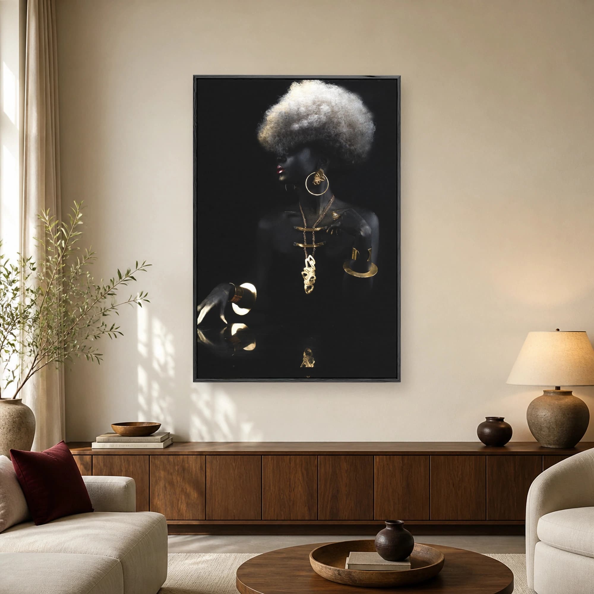 Fine art studio portrait of a model with black skin, gold jewelry, gold hand paint, and a voluminous silver-white afro hairstyle against a black background.