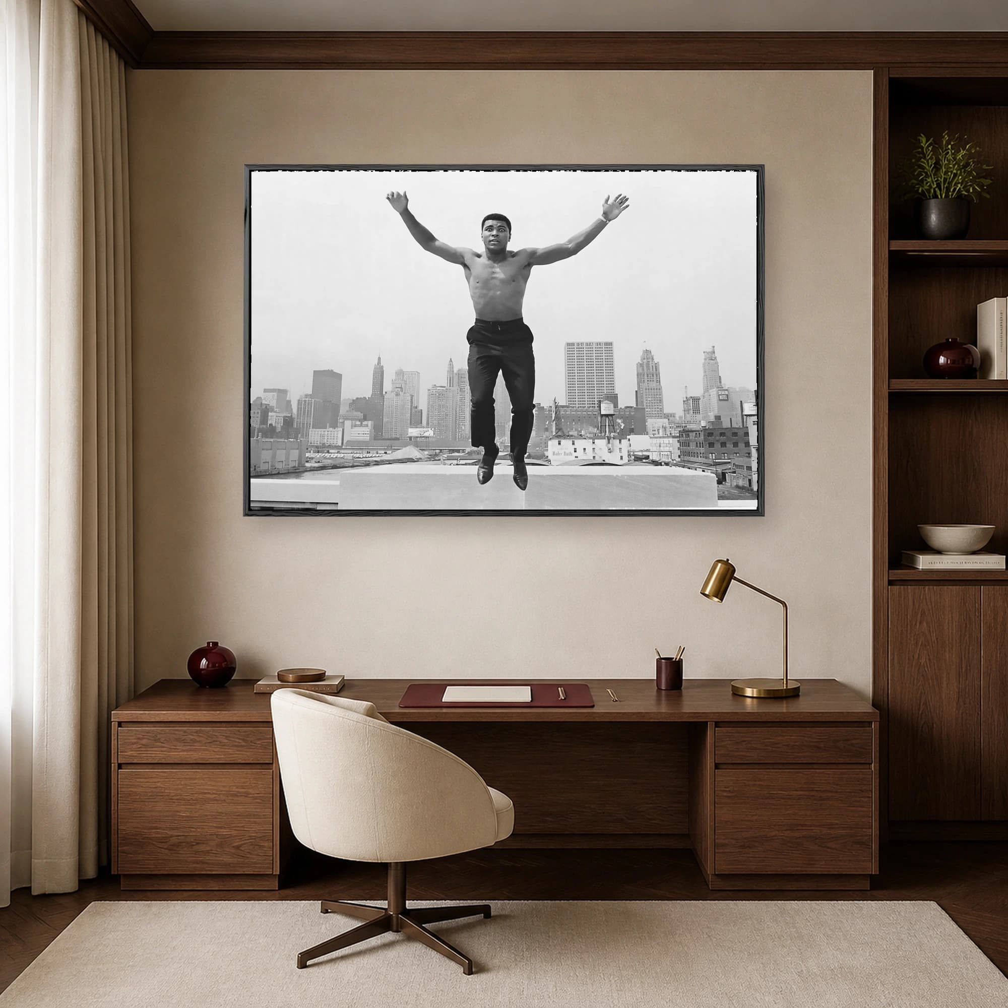 Black and white photograph of a shirtless Muhammad Ali leaping mid-air with outstretched arms above the Chicago skyline