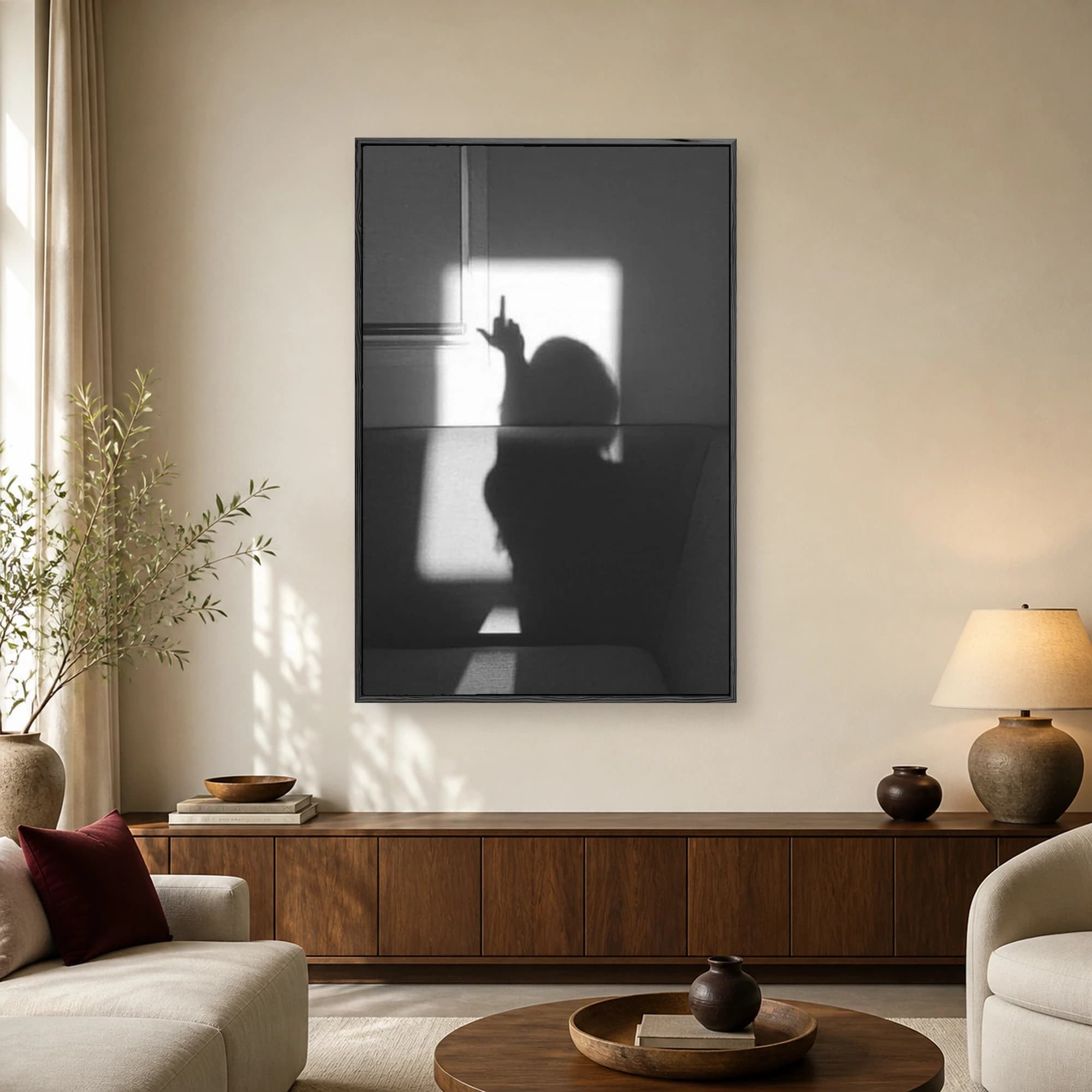 Monochrome photograph showing a dramatic wall shadow of a person holding up a middle finger gesture.