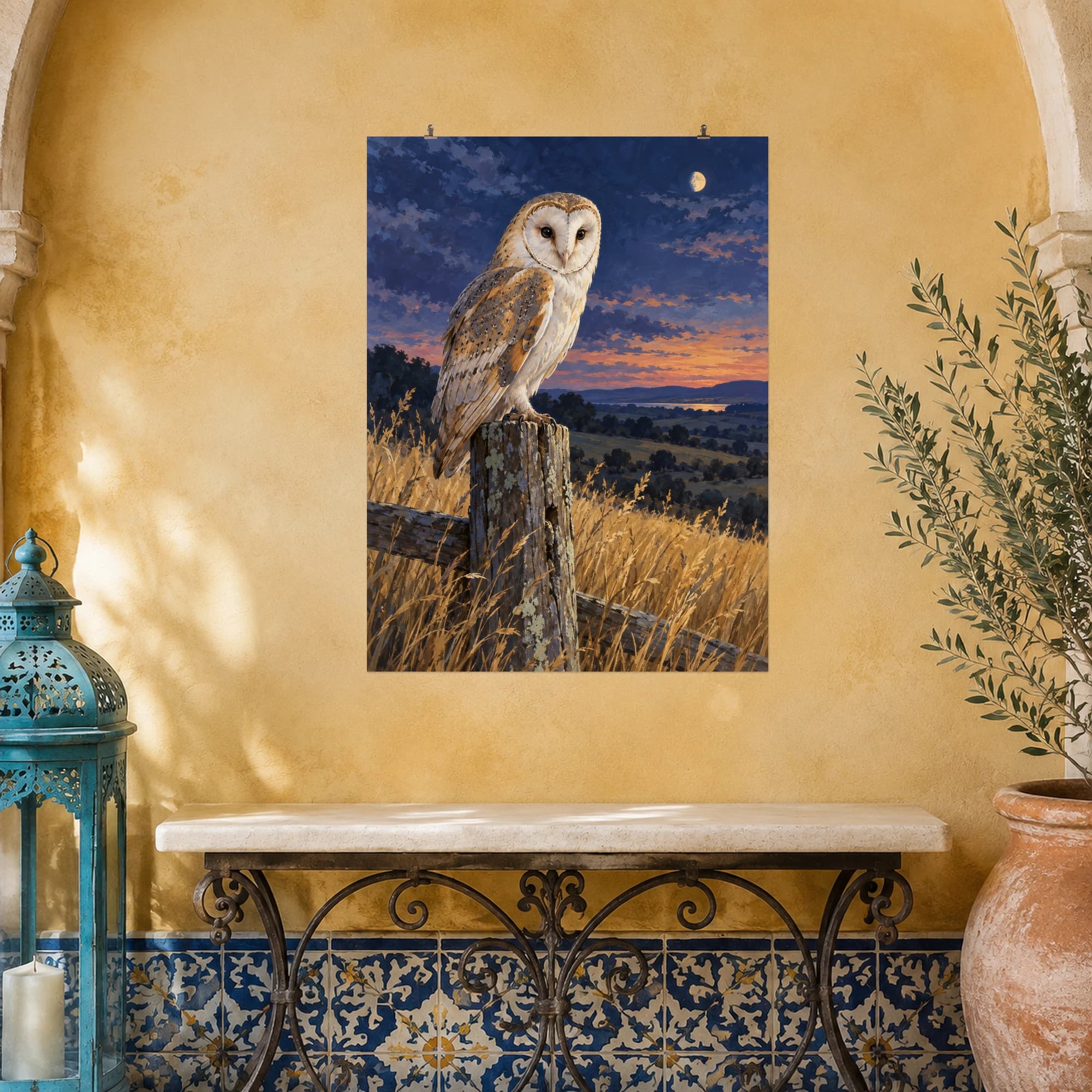 A barn owl watches from a weathered fence post beneath a small moon. Golden grasses and an indigo evening sky frame its pale heart-shaped face in this tranquil wildlife scene.