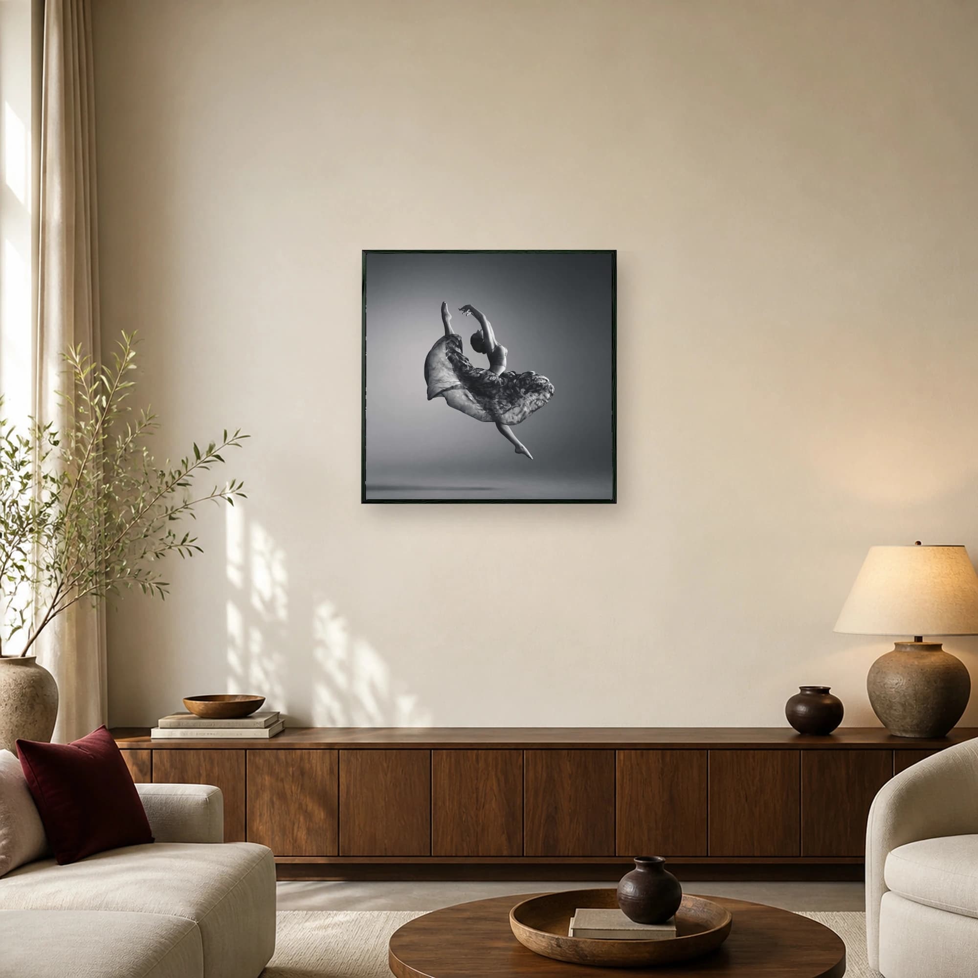 Black and white fine art photo of a female ballet dancer mid-air with flowing patterned skirt and outstretched arms.