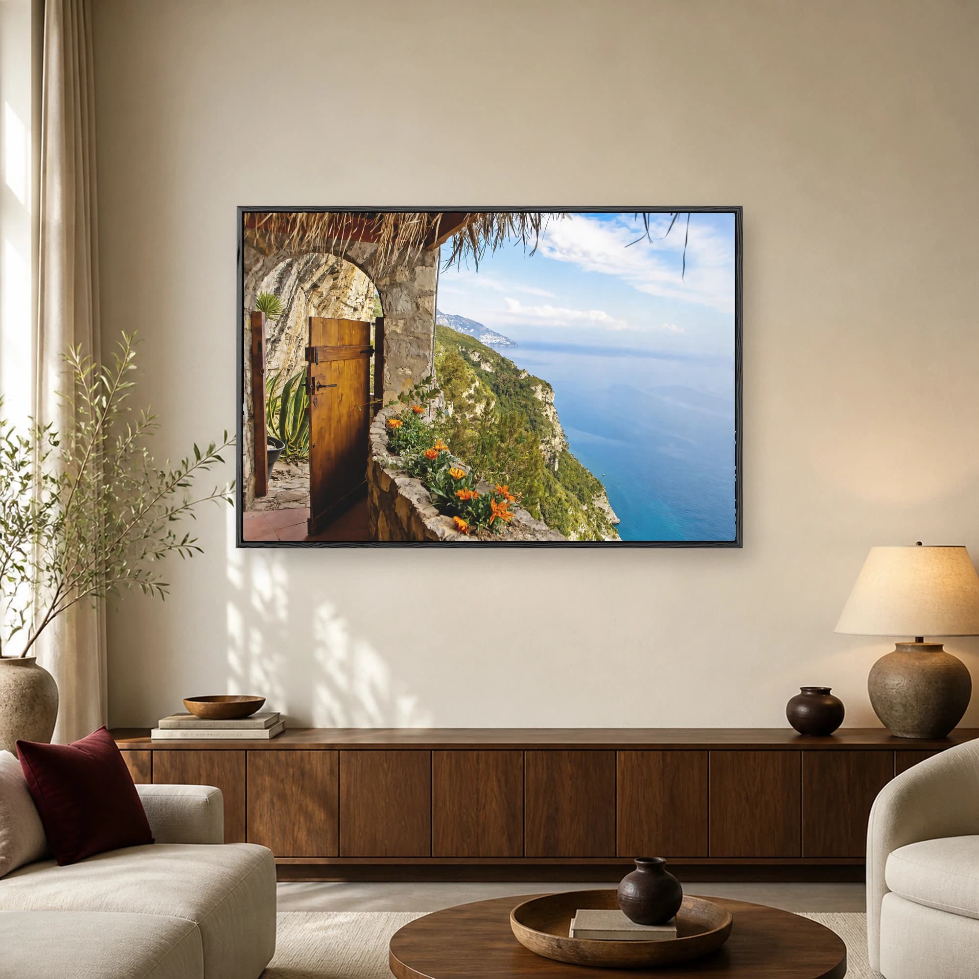 Sunlit stone balcony and open wooden door overlooking the vibrant cliffs and blue sea of the Amalfi Coast.
