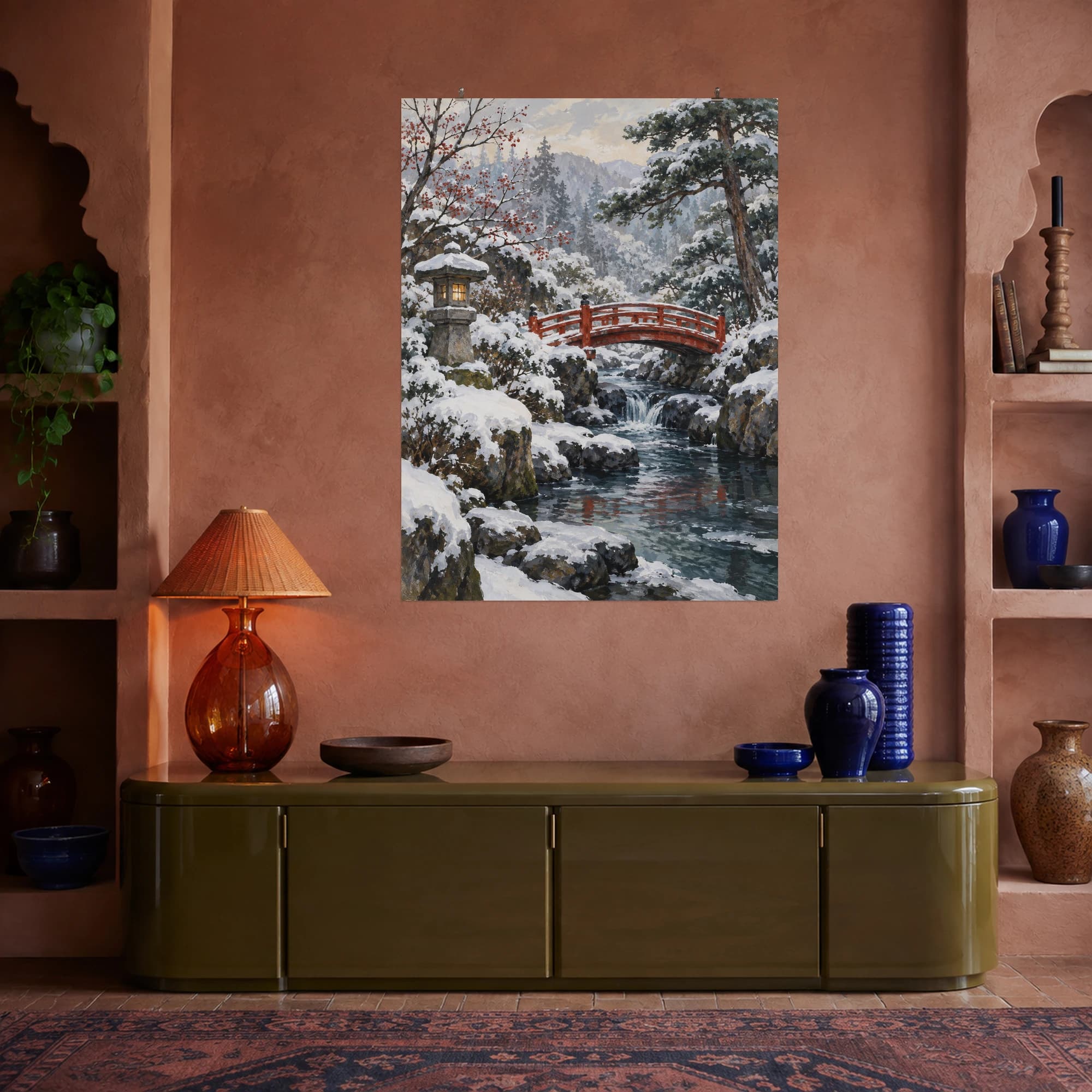 This gouache-style composition features a small red footbridge crossing a snowy stream with a stone lantern and pines in muted winter light. Expressive brushwork and a balanced palette bring warmth and character to your space.