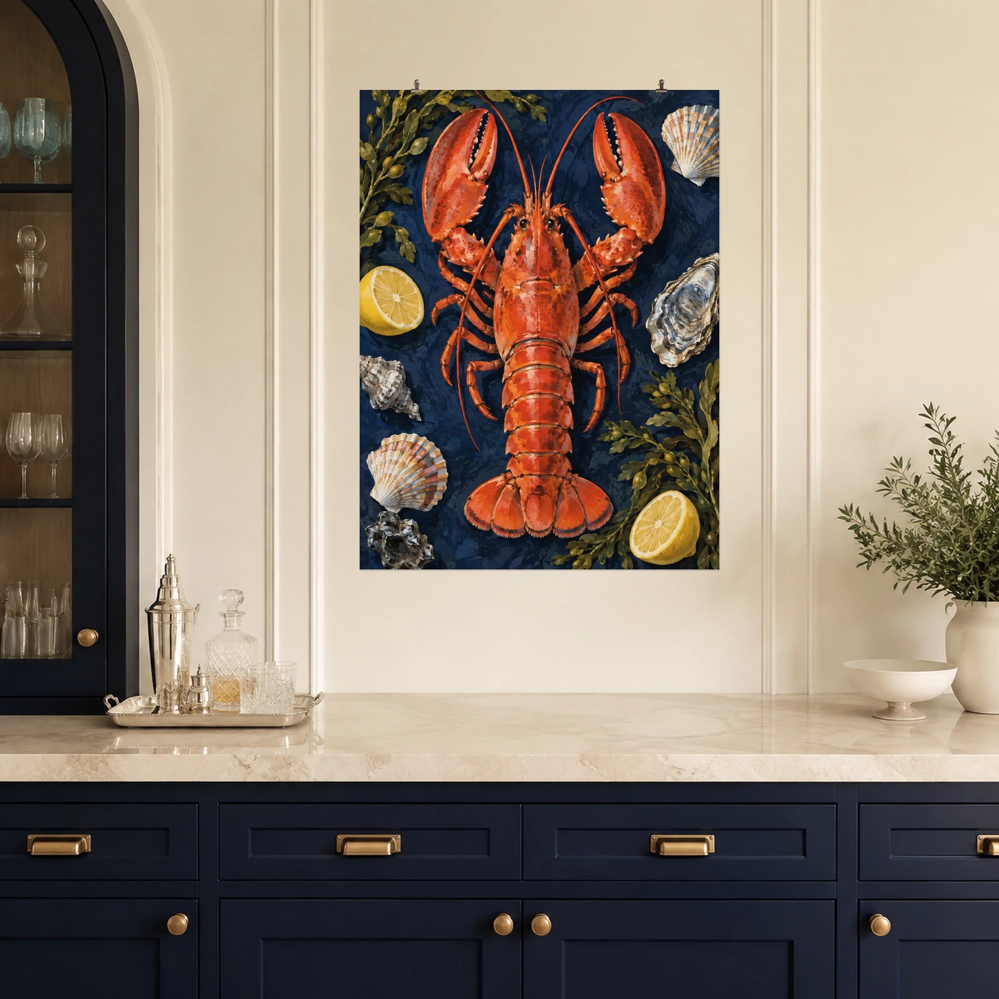 A coral red lobster takes center stage against navy blue, surrounded by shells, seaweed and lemon. Bold color and painterly detail bring seaside character to a kitchen or dining space.
