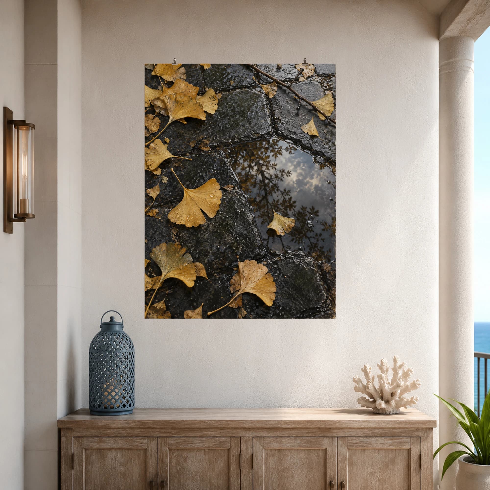 Golden ginkgo leaves scatter across a rain-darkened stone path.