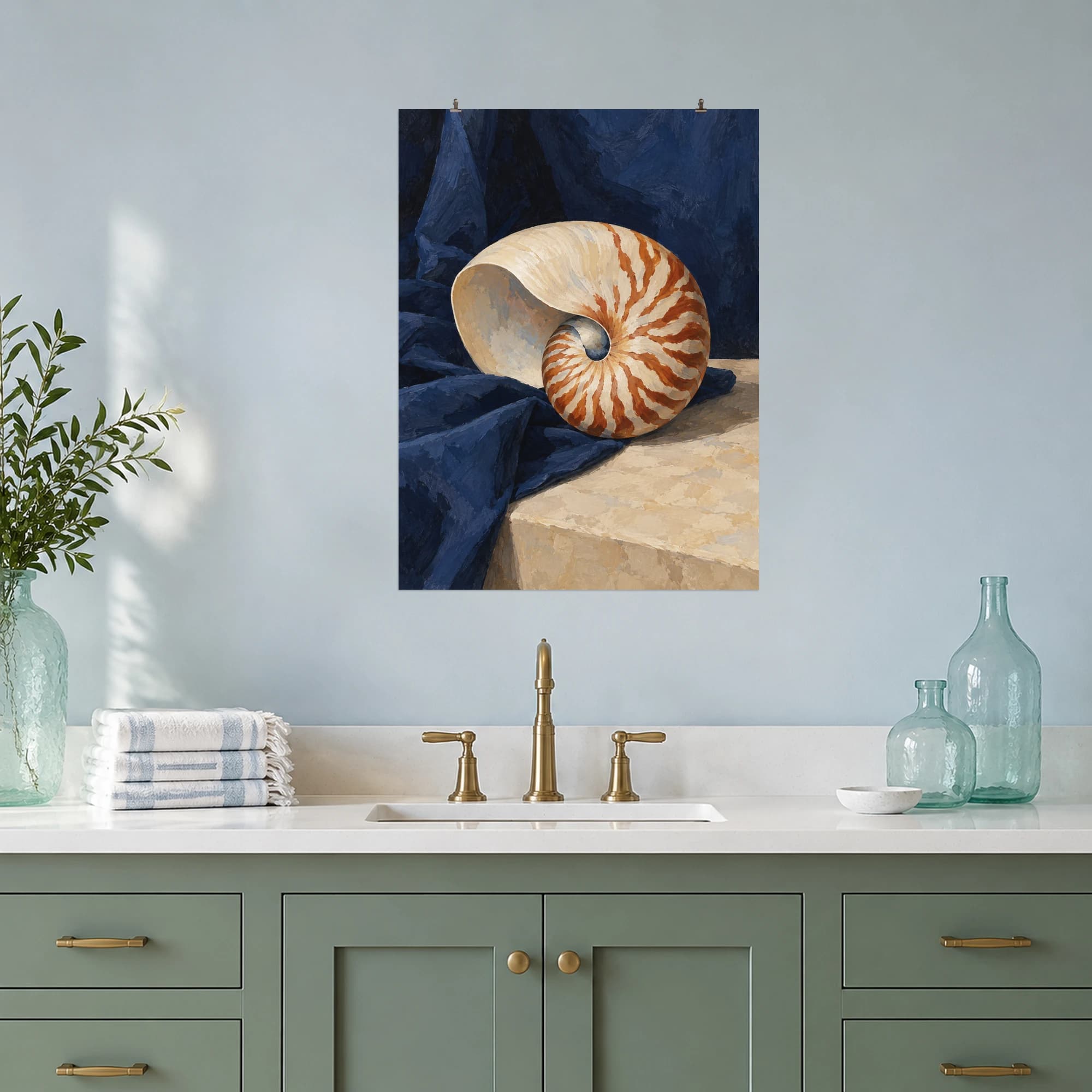 A cream and russet nautilus shell rests on deep indigo fabric.
