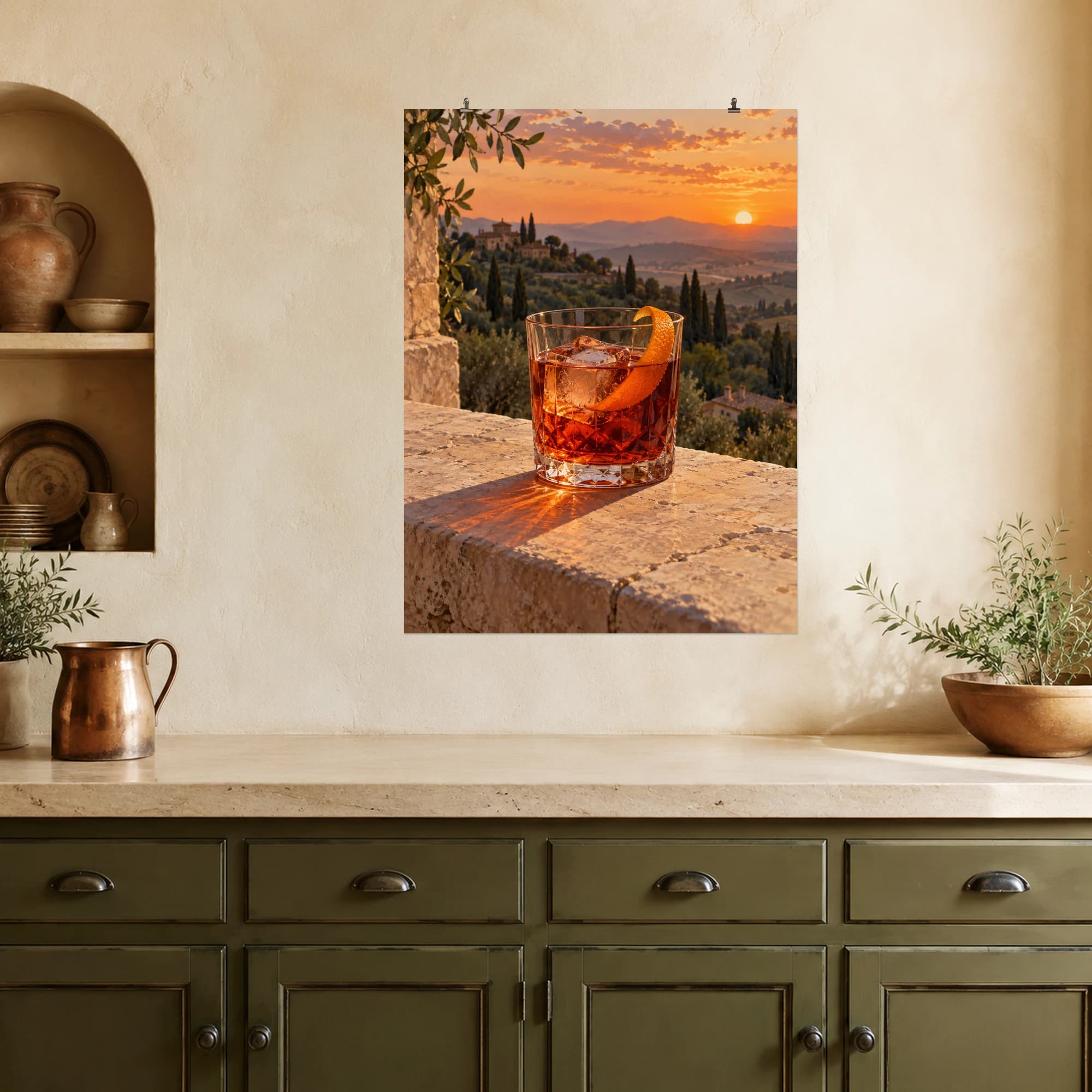 A ruby-orange negroni catches sunset light above a quiet Italian landscape.