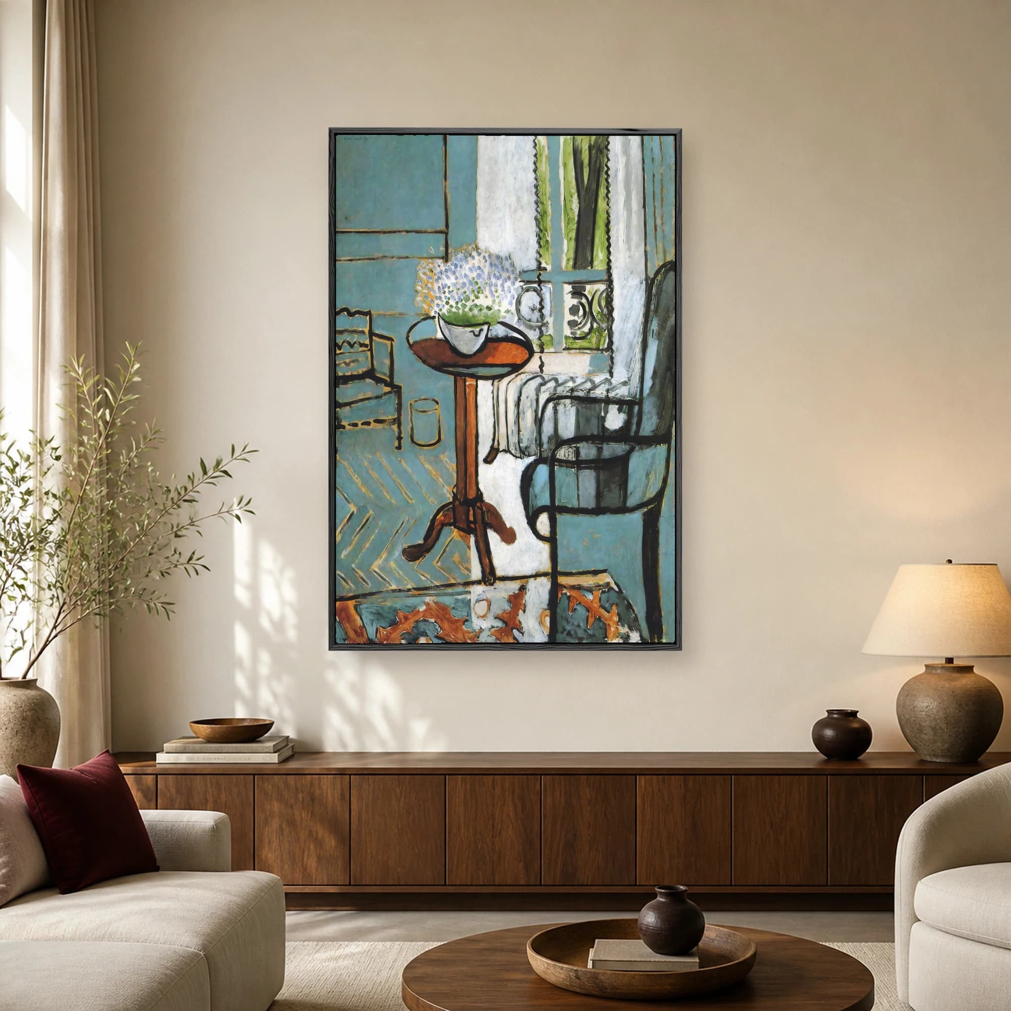 An interior art print showing a blue room with a wooden table, a bowl of white and blue flowers, an armchair, and a window with green trees.