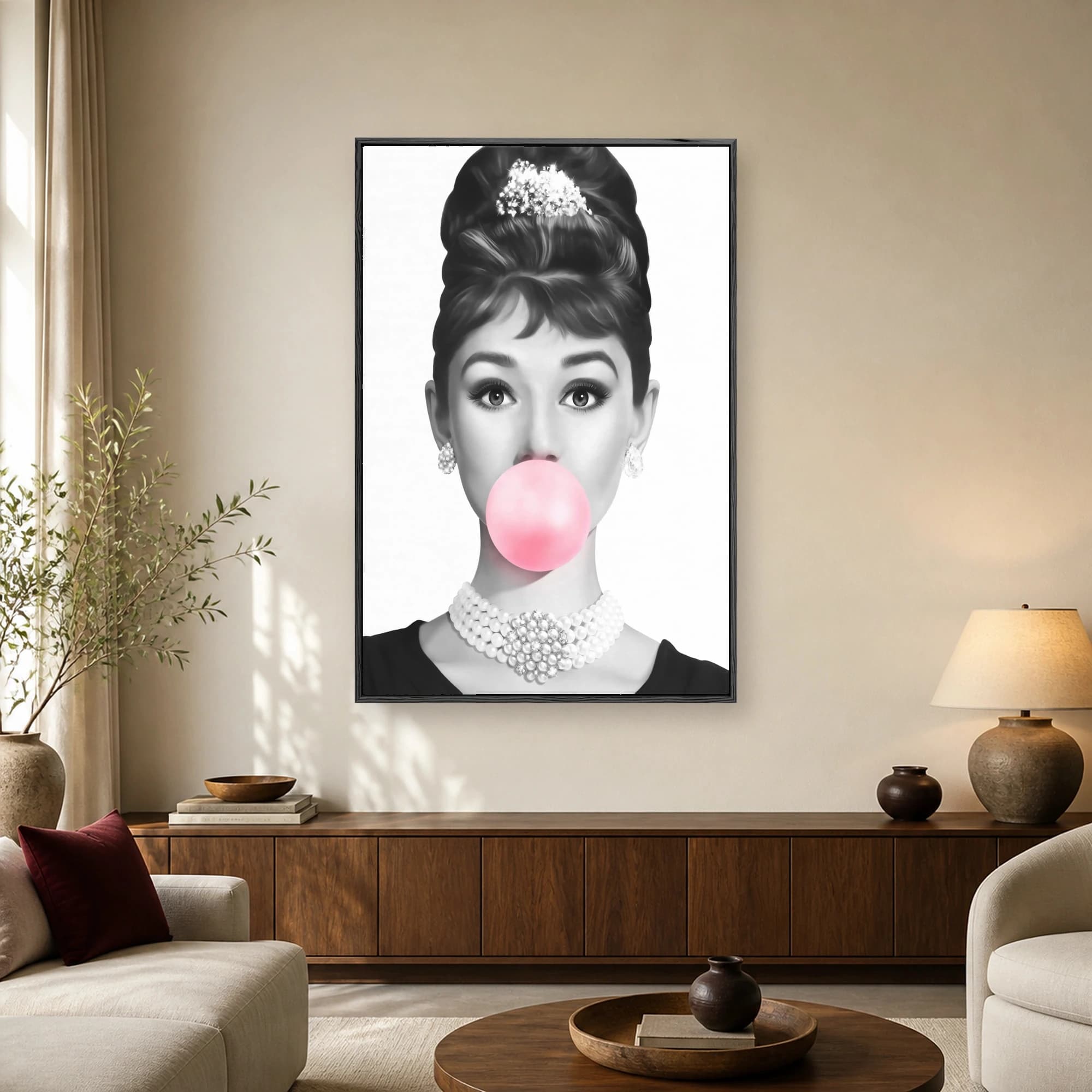 Monochrome portrait of Audrey Hepburn with a French twist updo, tiara, pearls, and a large bright pink bubblegum bubble covering her mouth.