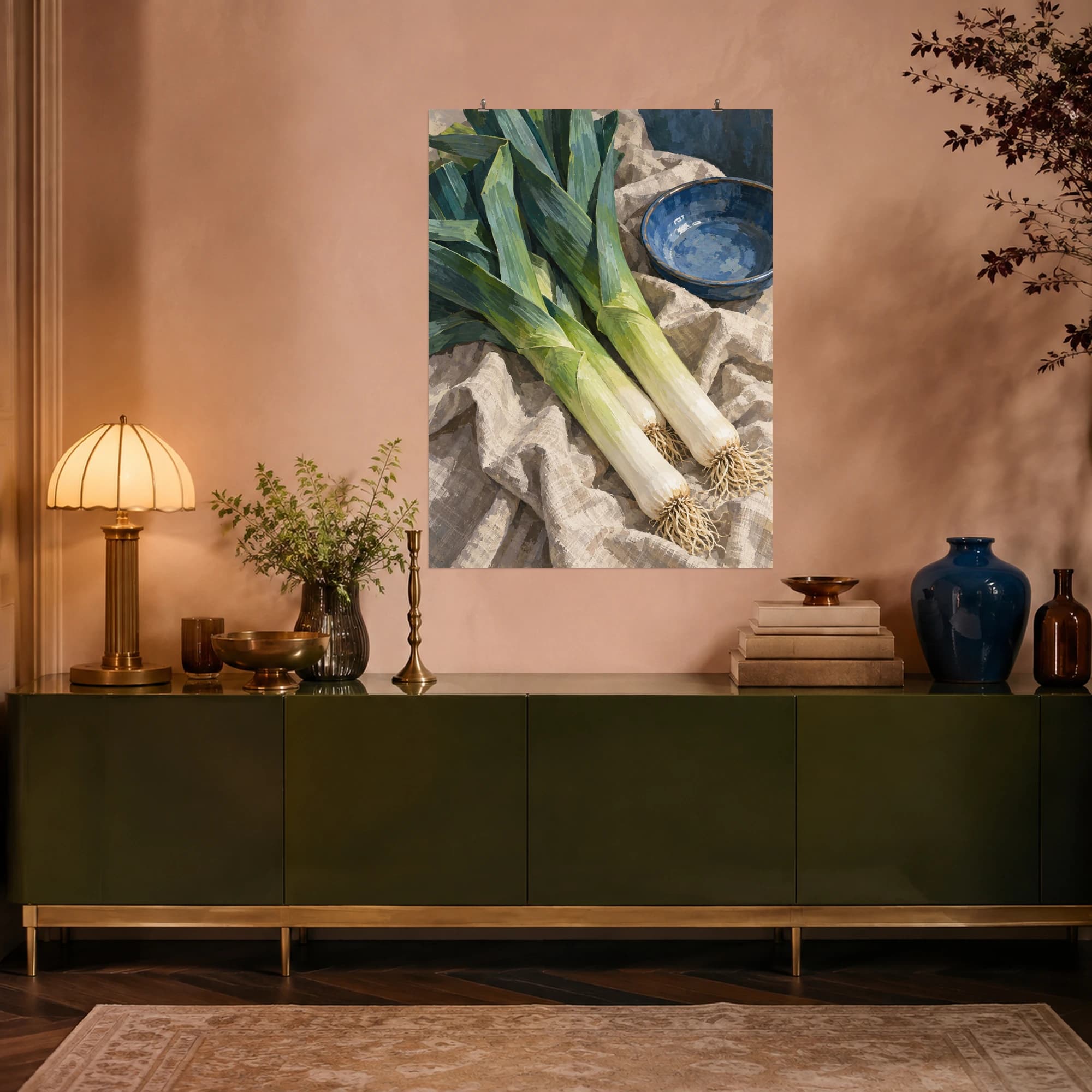 This gouache-style composition features fresh leeks arranged diagonally across rumpled oatmeal linen beside a simple blue ceramic dish. Expressive brushwork and carefully balanced color bring a distinctive focal point to your wall.