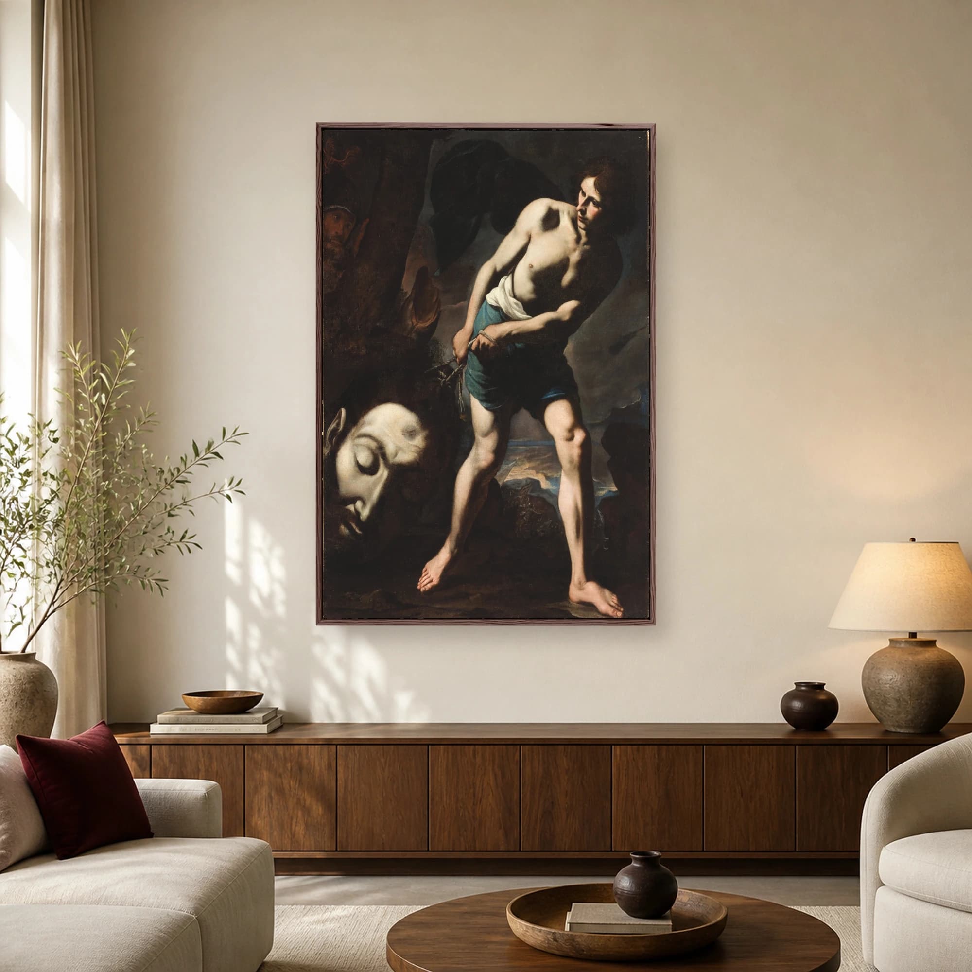 Baroque painting of a youthful David holding the rope attached to the giant severed head of Goliath against a dark background.