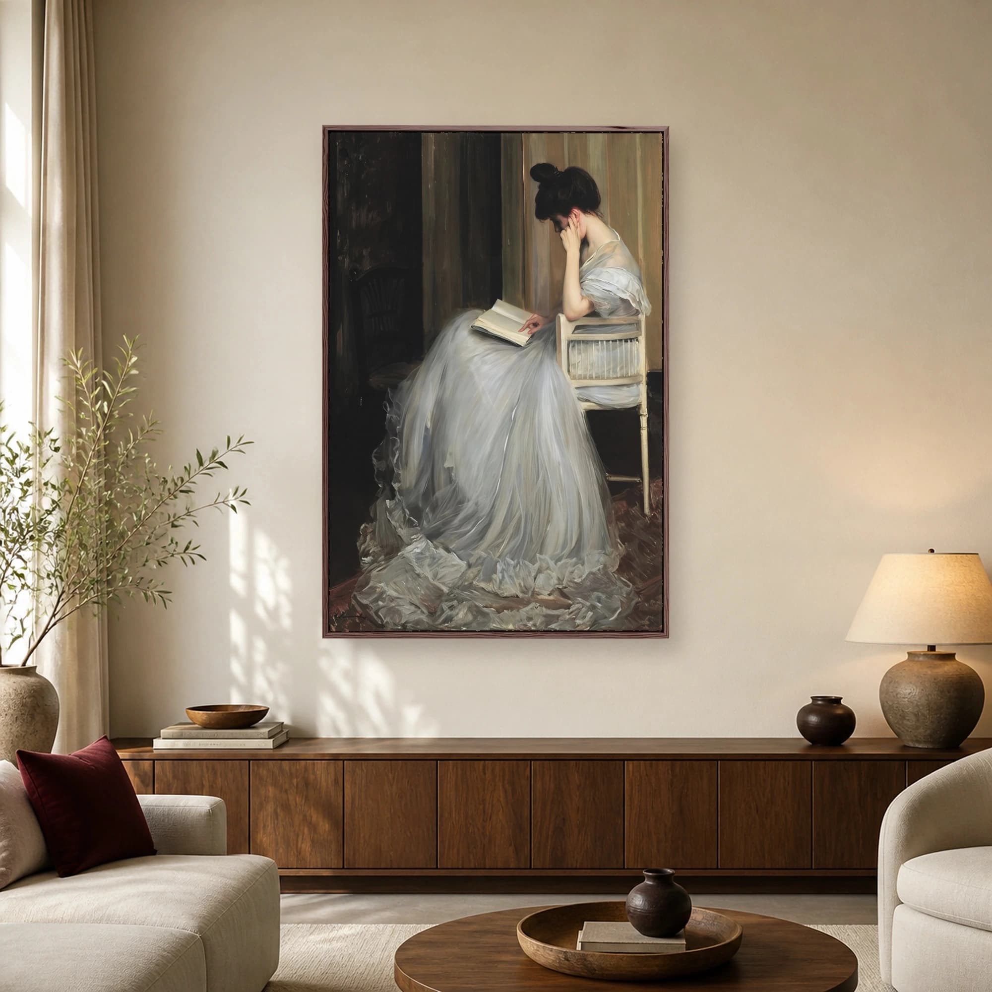 A classic oil painting of a woman in an airy grey gown seated on a chair, reading a book.