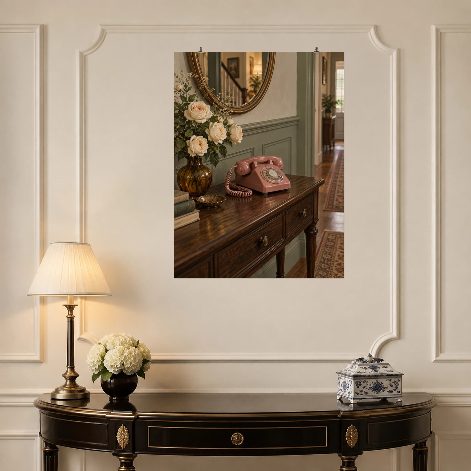 A dusty rose rotary telephone and cream roses brighten a walnut console in a quiet hallway.