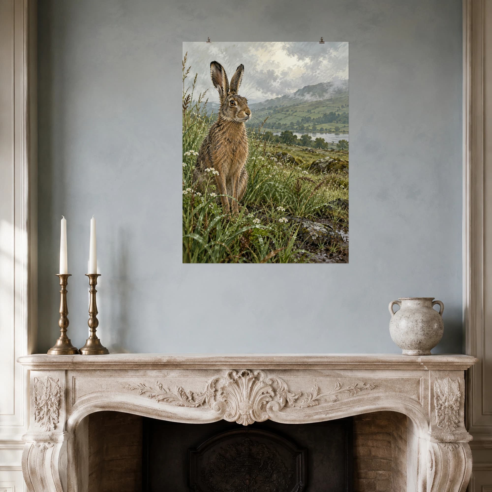 A brown hare pauses among wet grasses and tiny wildflowers after rain.