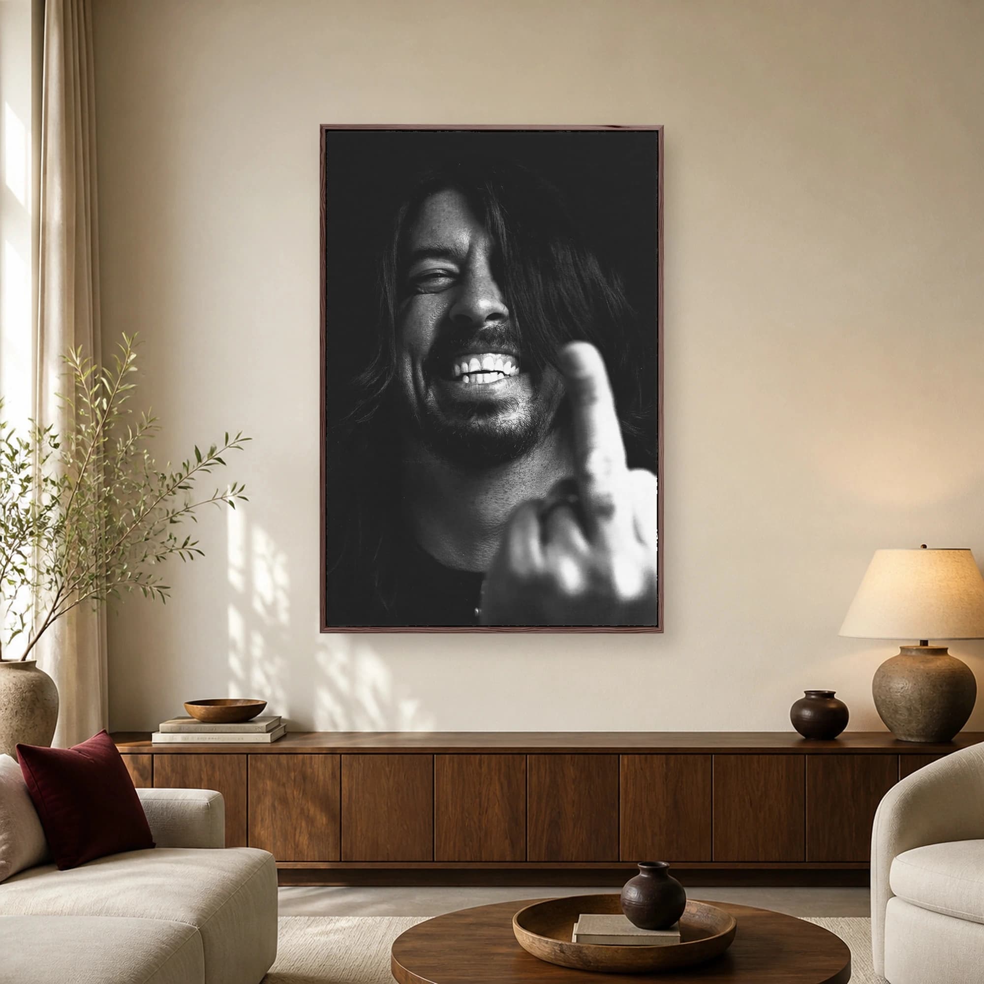 High-contrast black and white portrait of rock musician Dave Grohl laughing while holding up his middle finger in the foreground.