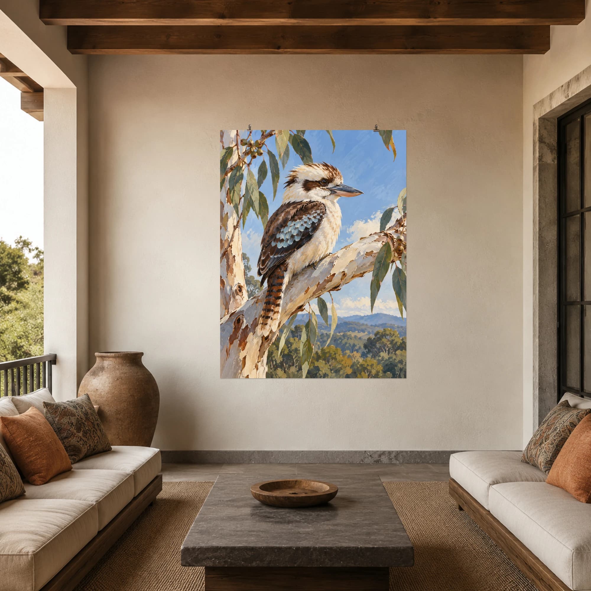 This gouache-style composition features a kookaburra perched on a pale eucalyptus branch against a muted blue morning sky. Expressive brushwork and carefully balanced color bring a distinctive focal point to your wall.