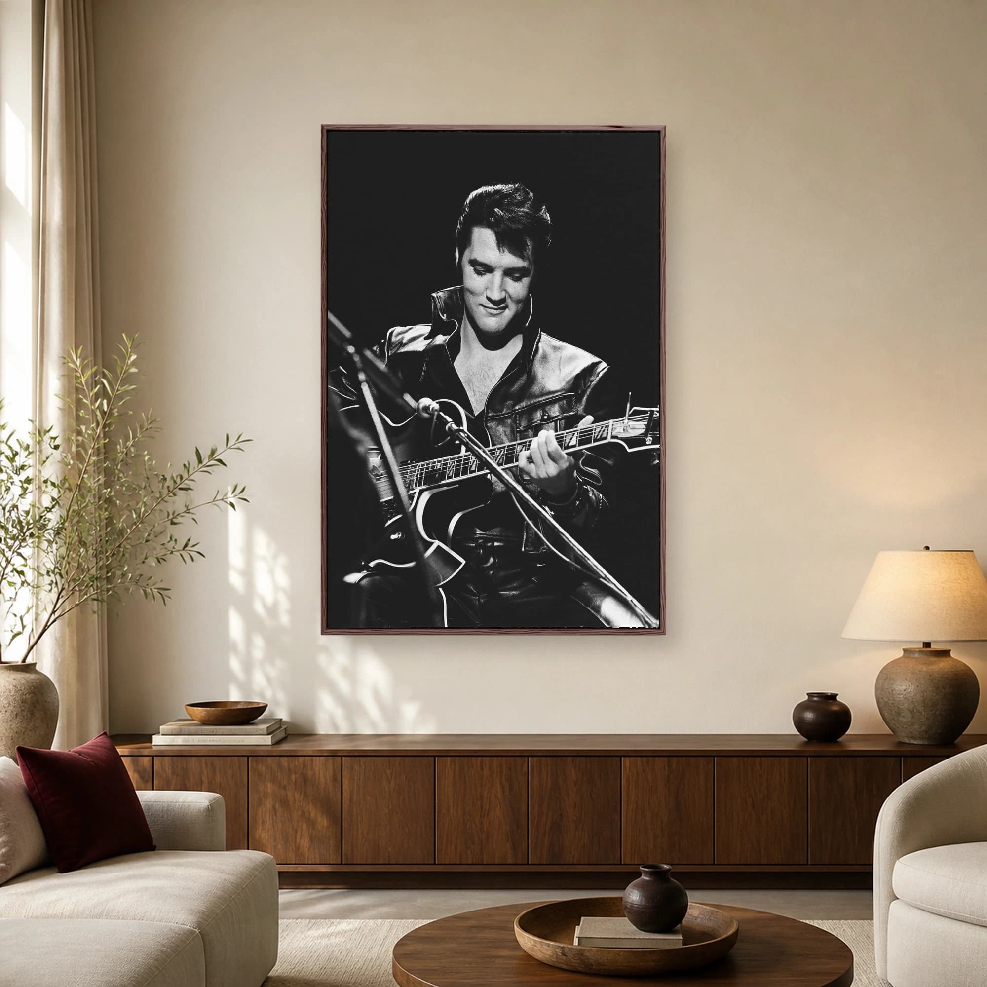 Black and white photo of Elvis Presley wearing a high-collared black leather jacket while playing guitar during his 1968 performance.