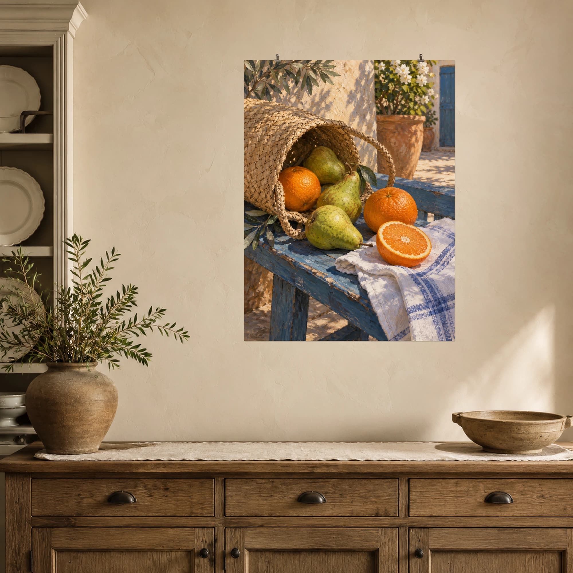 Green pears and bright oranges tumble from a woven market bag onto a rustic blue bench.