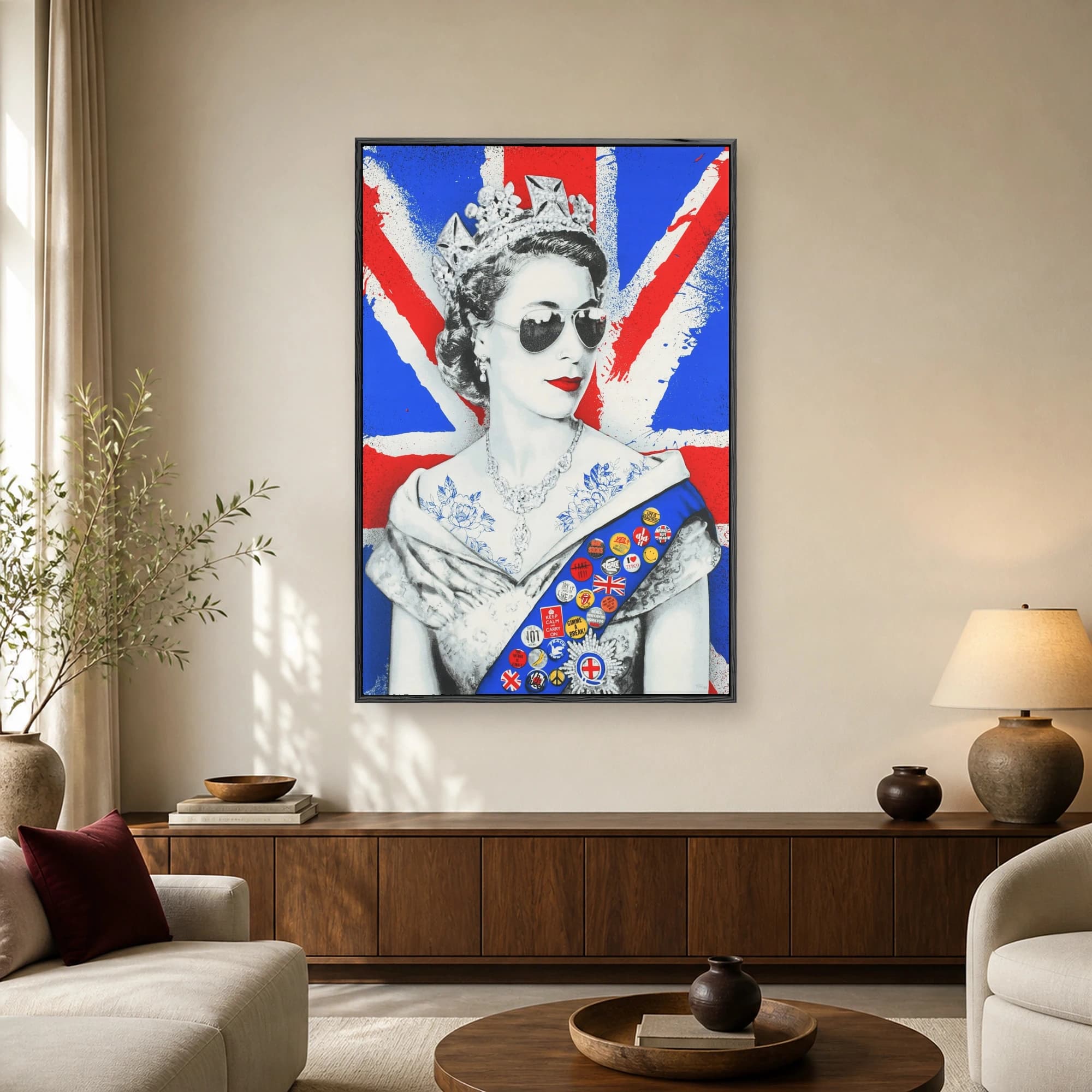Pop art portrait of Queen Elizabeth II with sunglasses, tattoos, and punk badges against a spray-painted Union Jack background.
