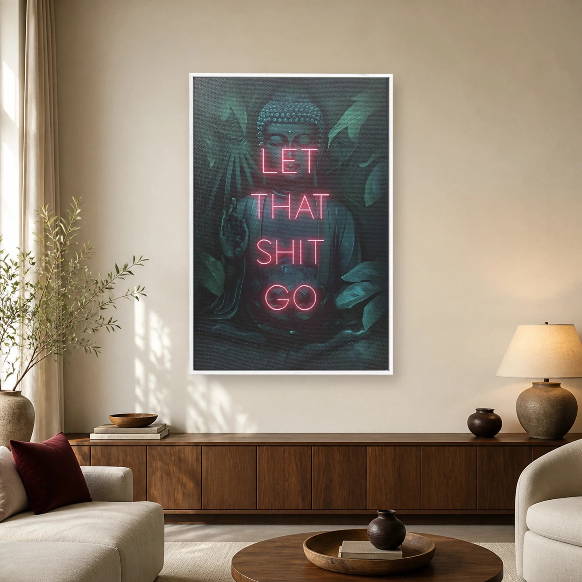 A canvas art print depicting a dark, moody Buddha statue surrounded by jungle leaves, overlaid with glowing neon pink text that reads LET THAT SHIT GO.