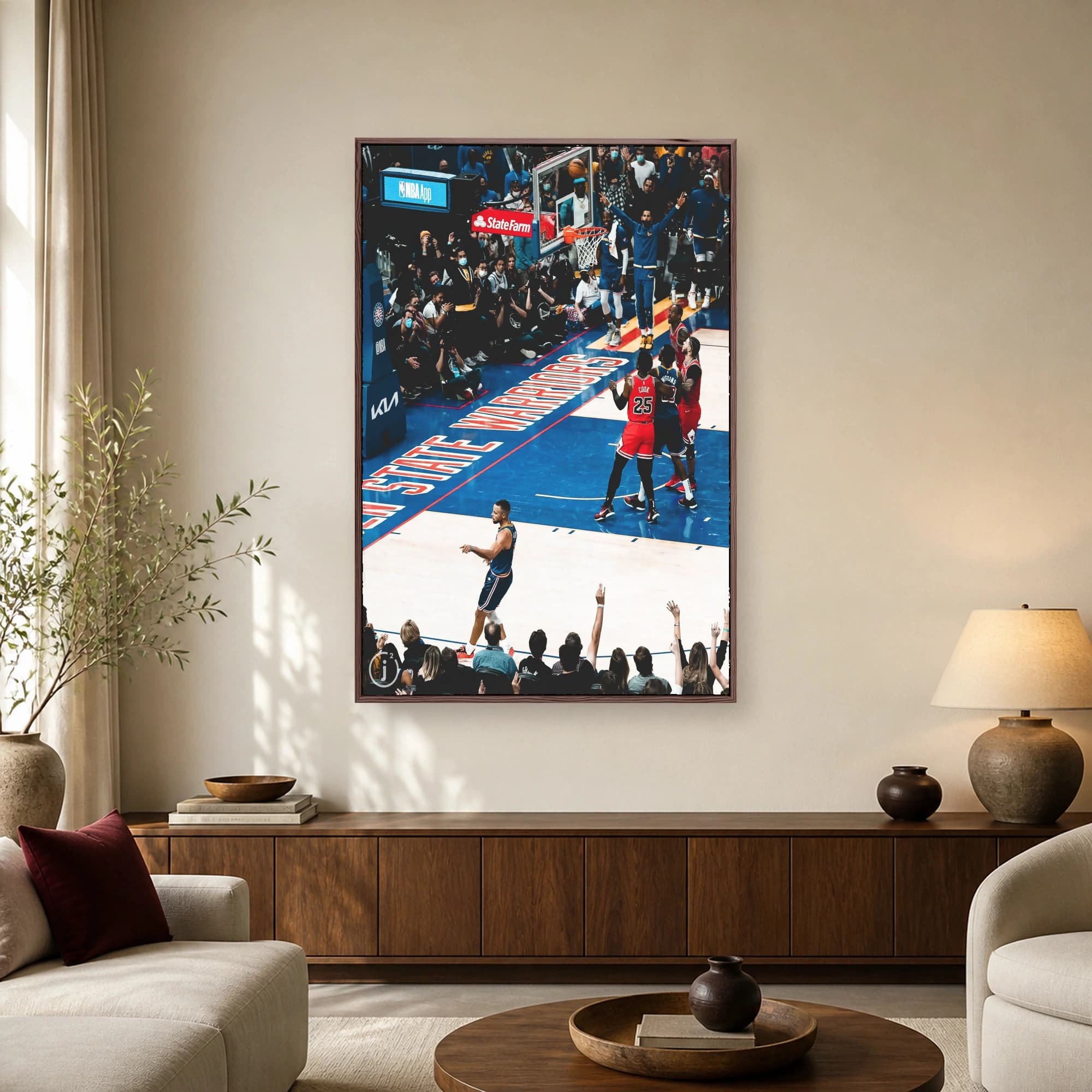 High angle sports photograph of Stephen Curry turning back on court with Golden State Warriors floor logo and Chicago Bulls players under the basket.