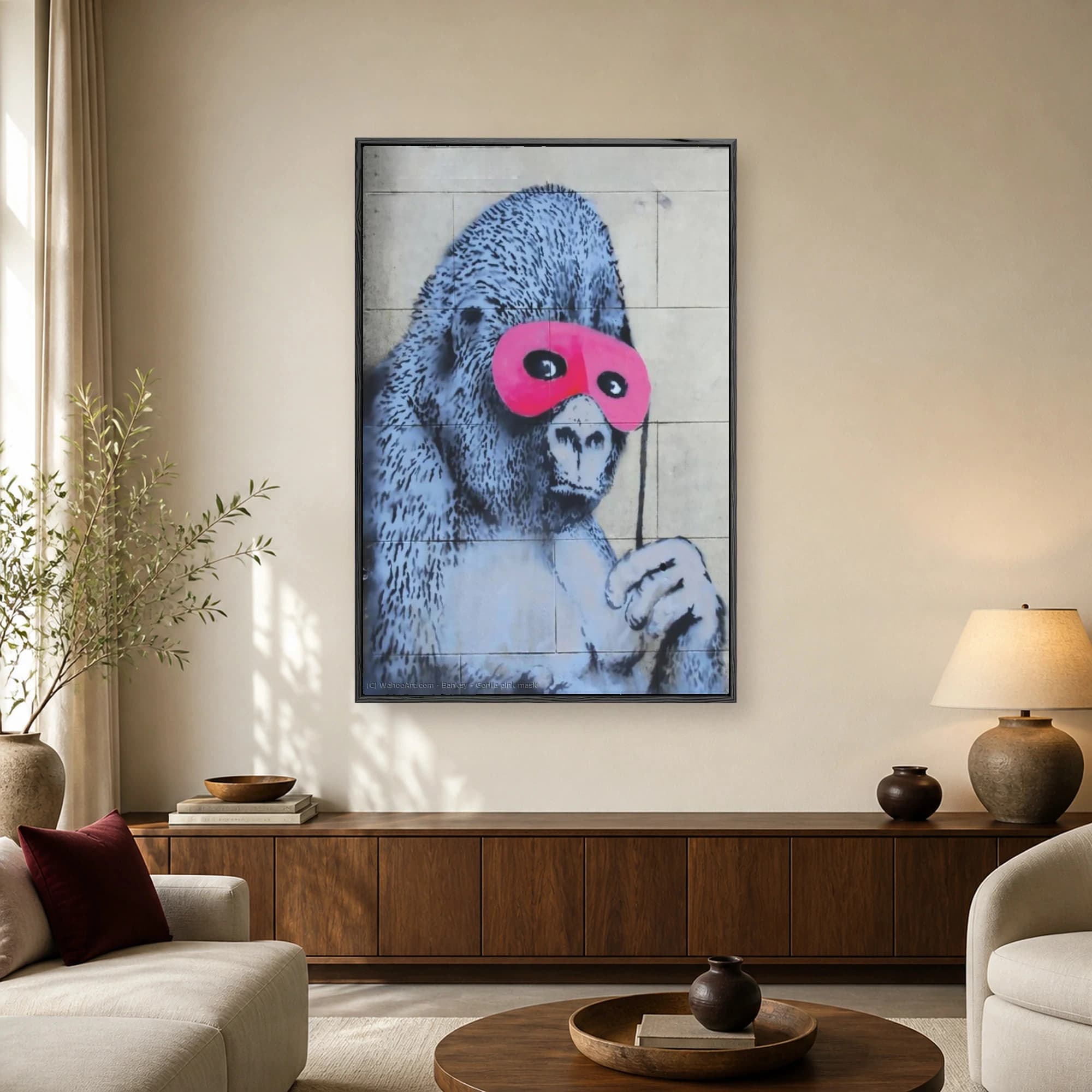 Urban street art stencil of a detailed monochrome gorilla wearing a bright pink eye mask on a stone wall background.