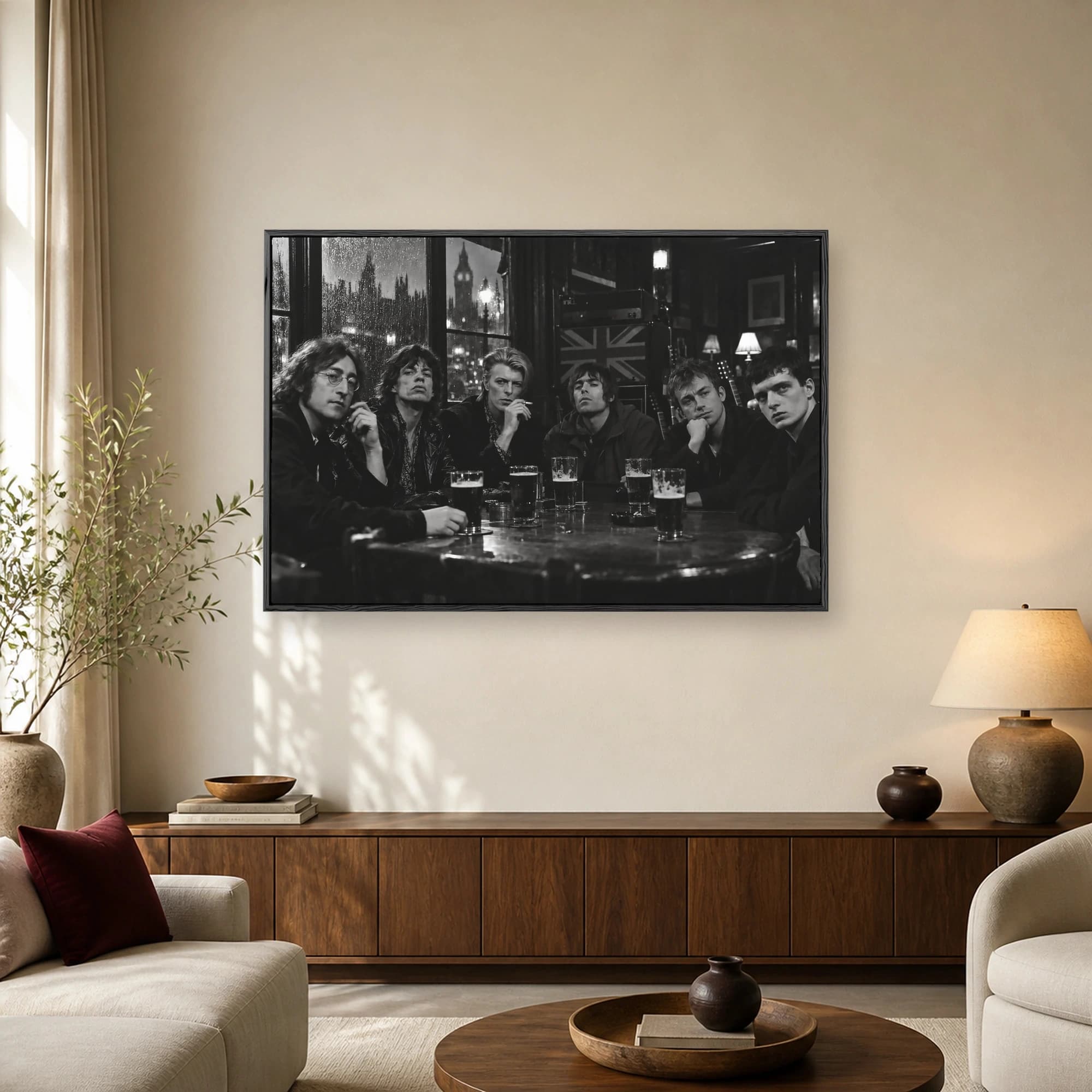Black and white photographic wall art of famous British musicians sitting around a pub table with pints of beer and a rainy London skyline outside the window.