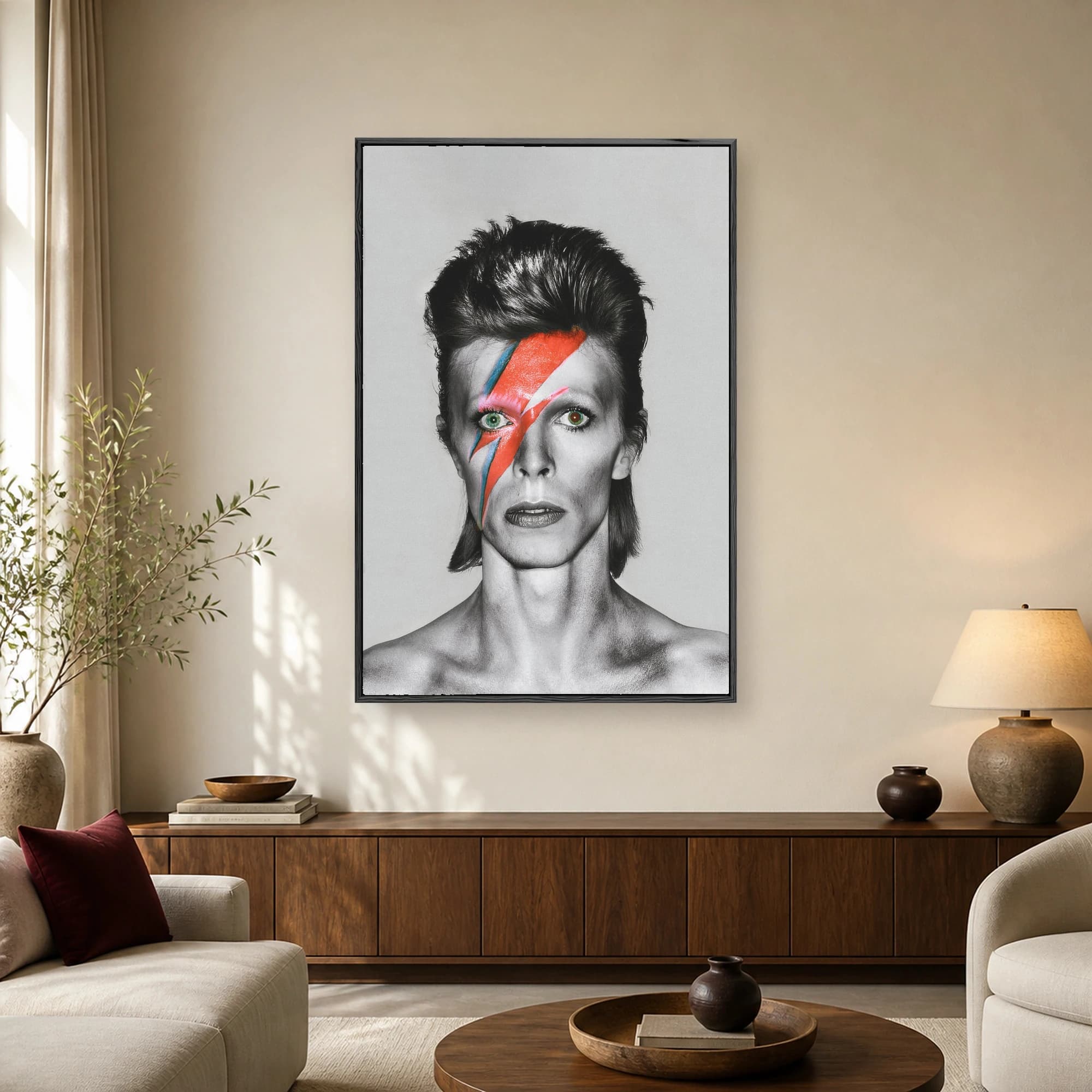 Monochrome portrait of David Bowie with the iconic red and blue lightning bolt painted across his face and spiky hair.
