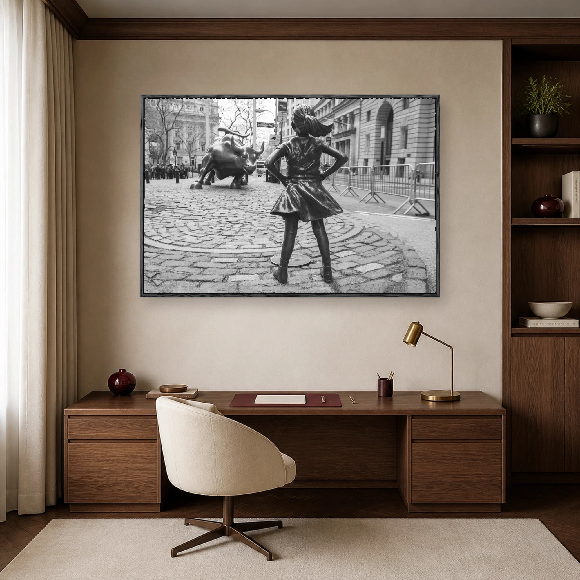 Black and white fine art photo of the Fearless Girl statue facing the Charging Bull sculpture on a cobblestone street in New York City